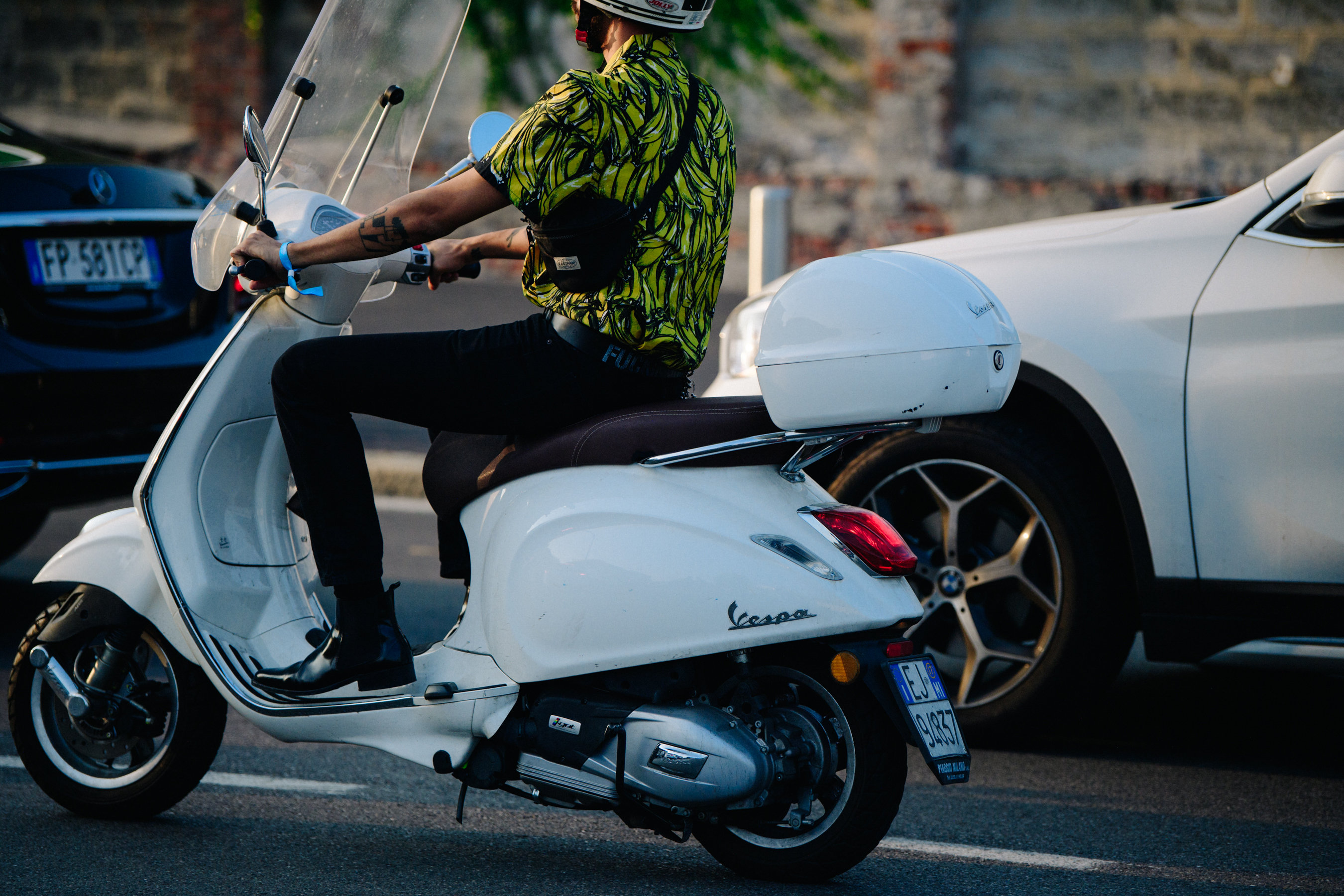 Man riding scooter in Prada