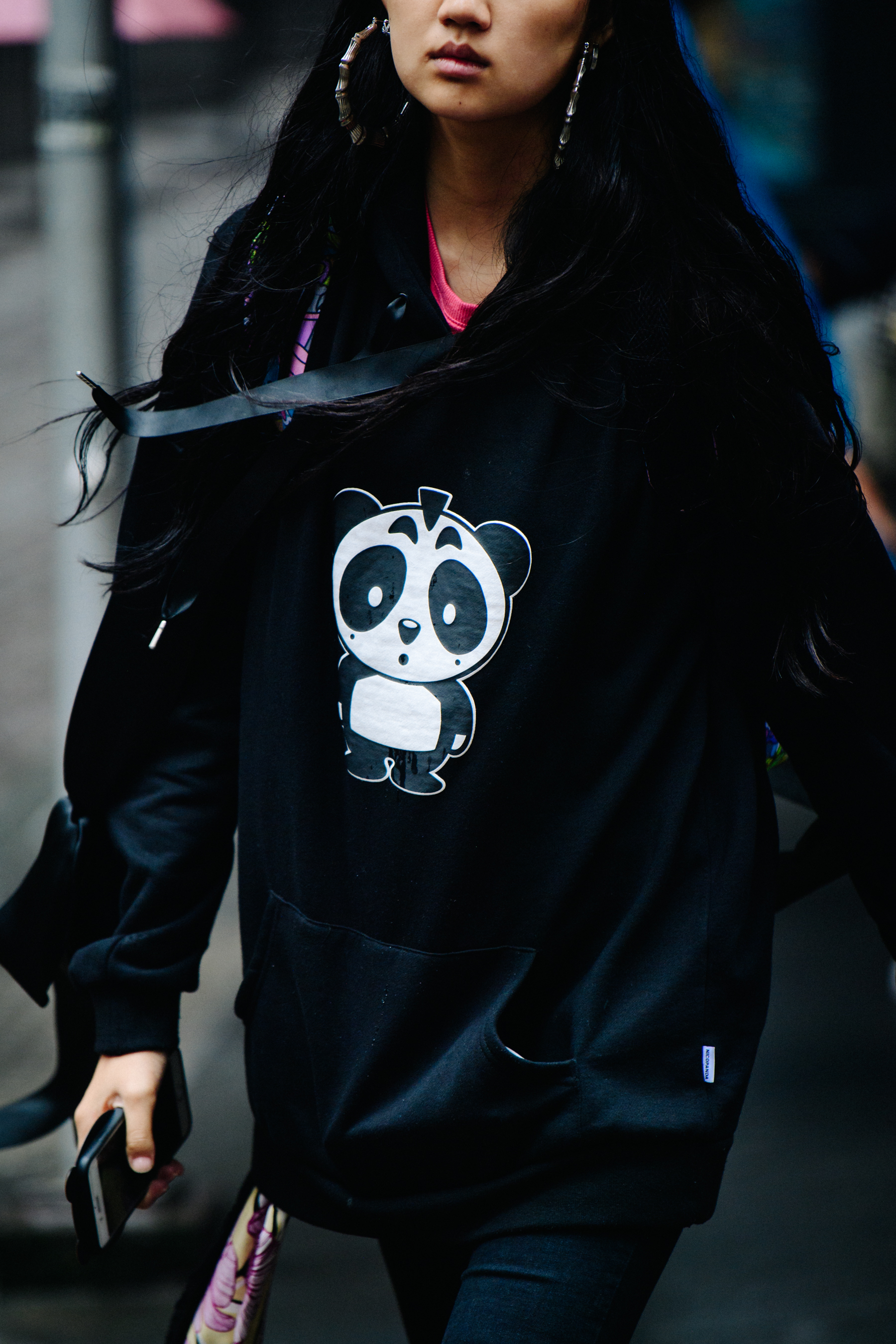 Asian woman wearing black Panda hoodie