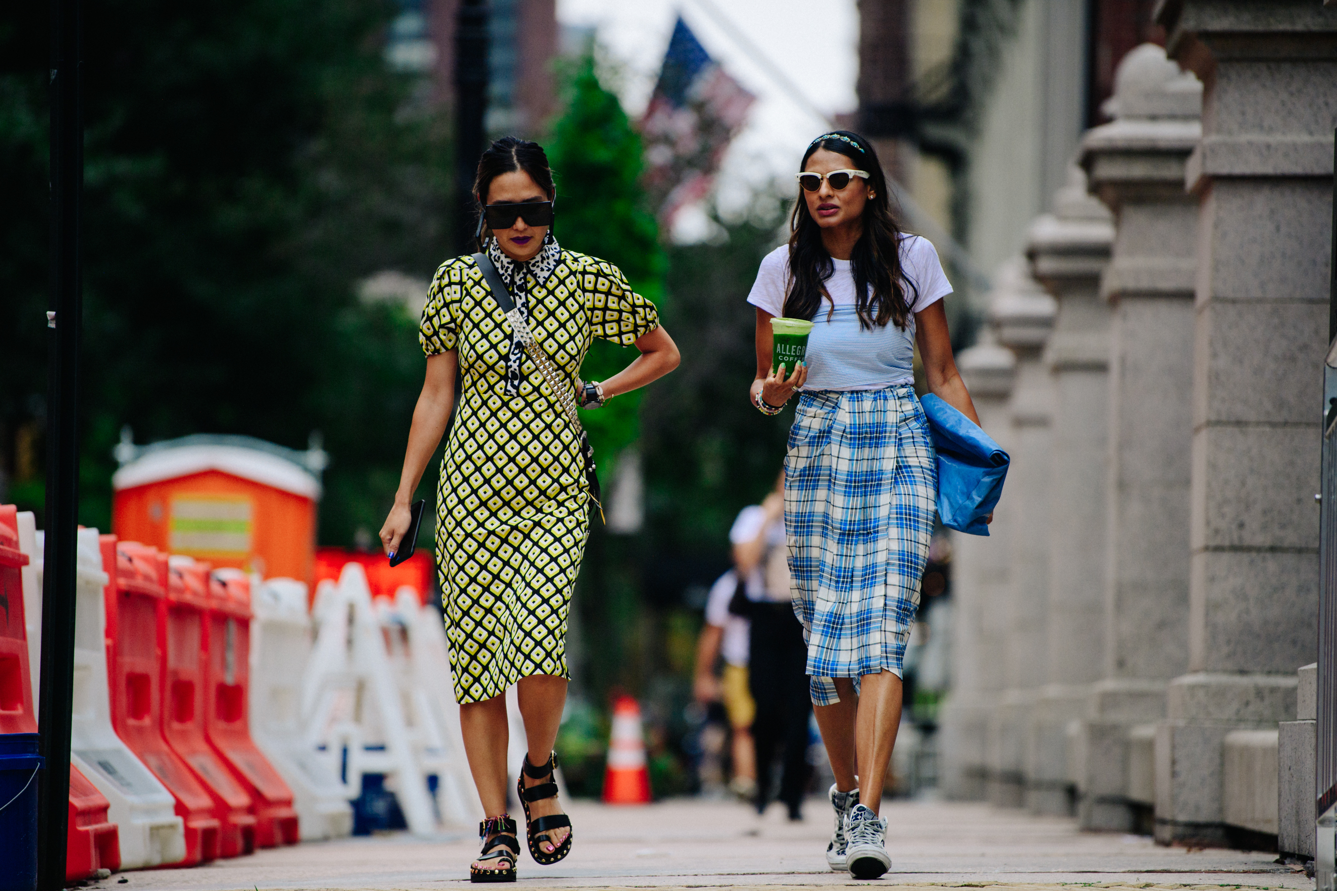 Two women wearing pattern dresses
