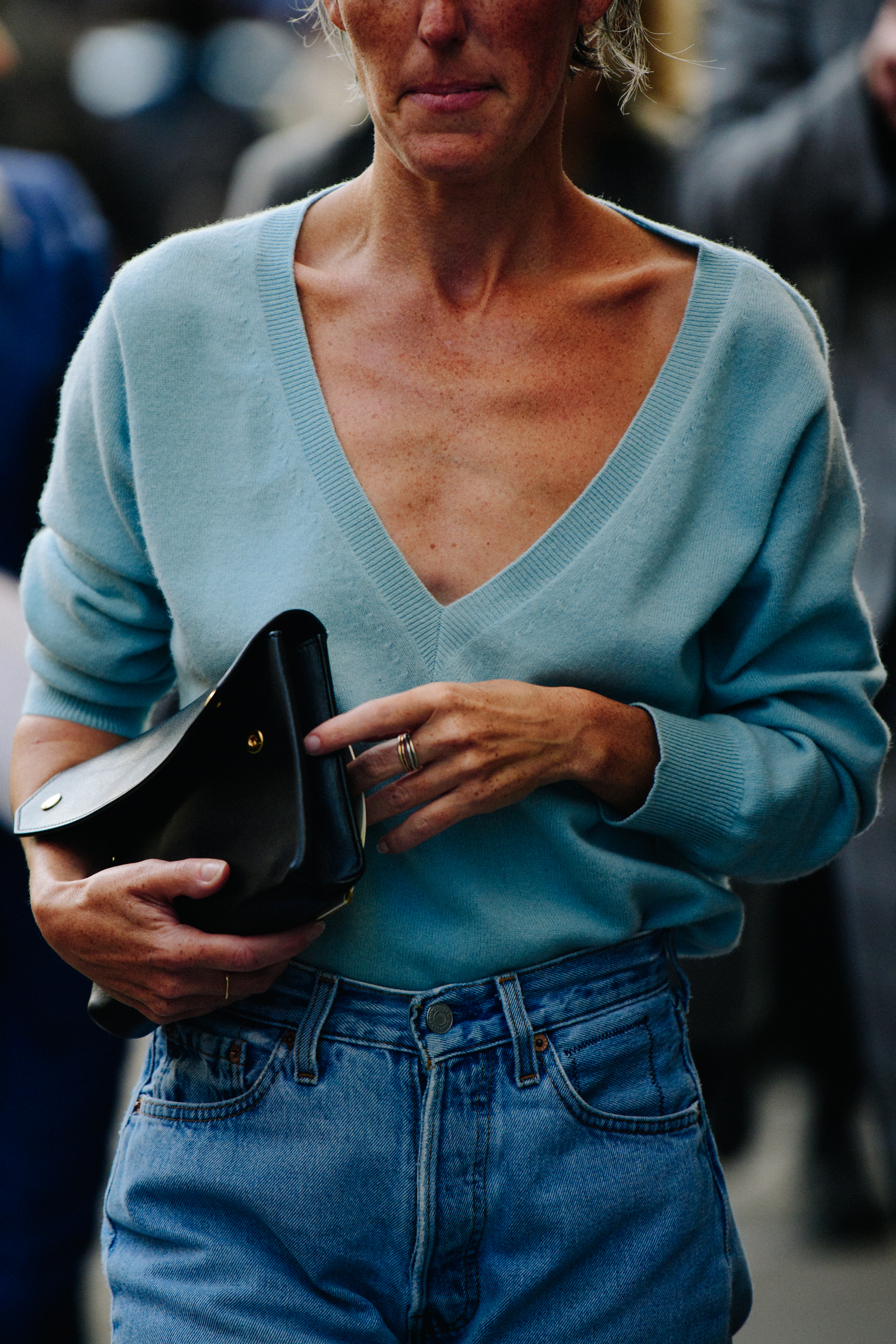 Woman wearing blue v neck jumper