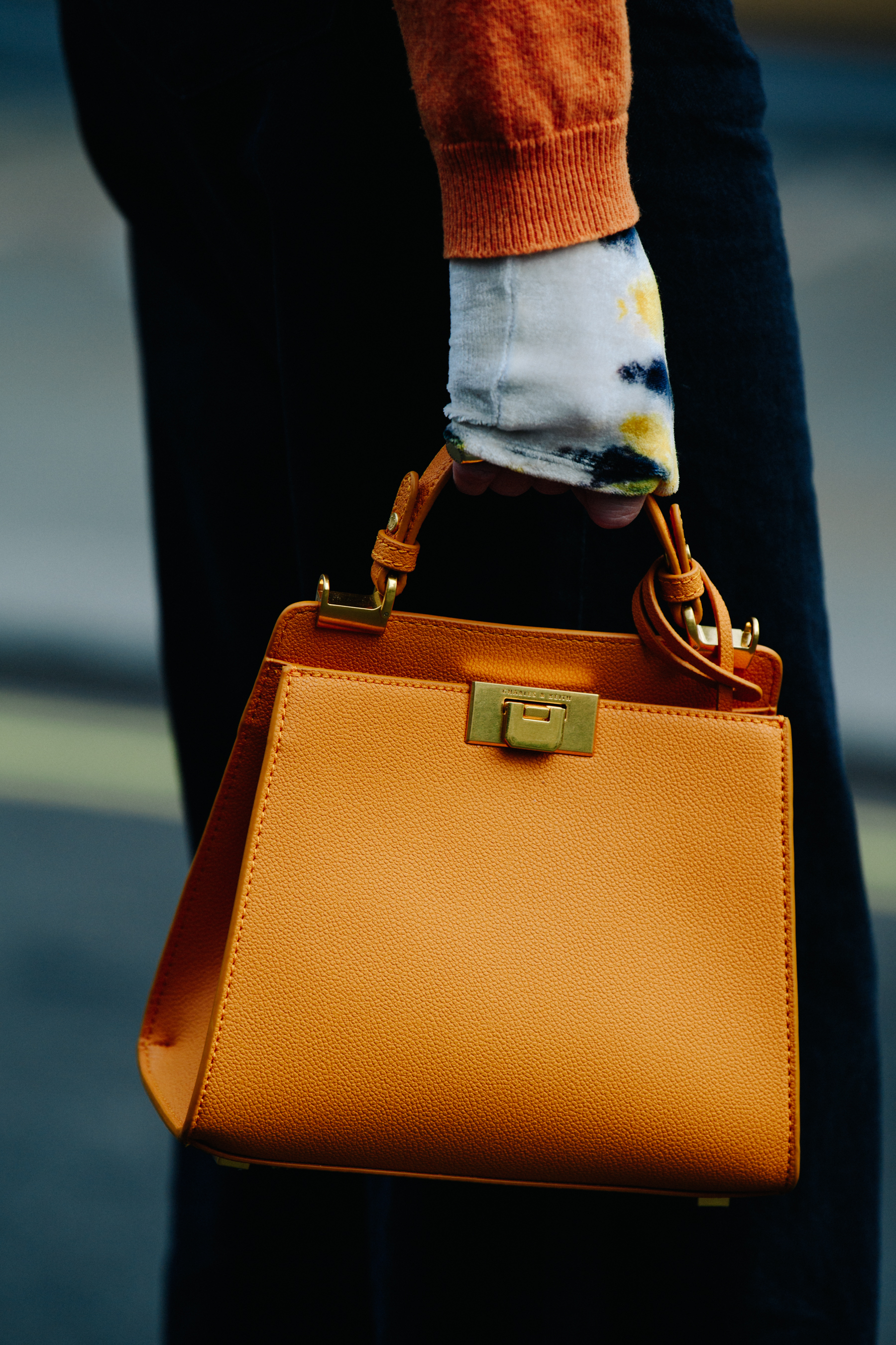 Woman carrying orange bag