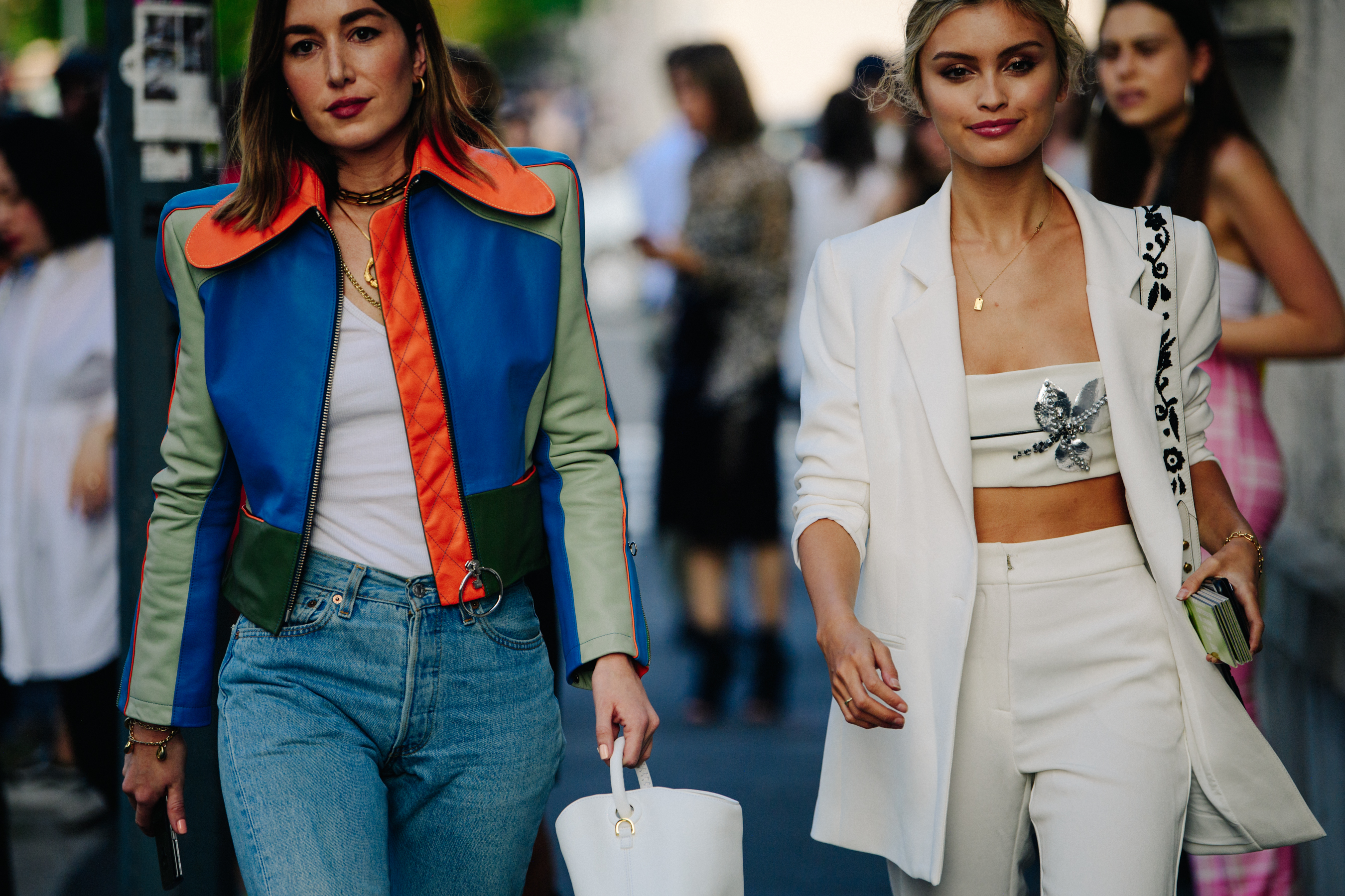 Two women wearing stylish jackets