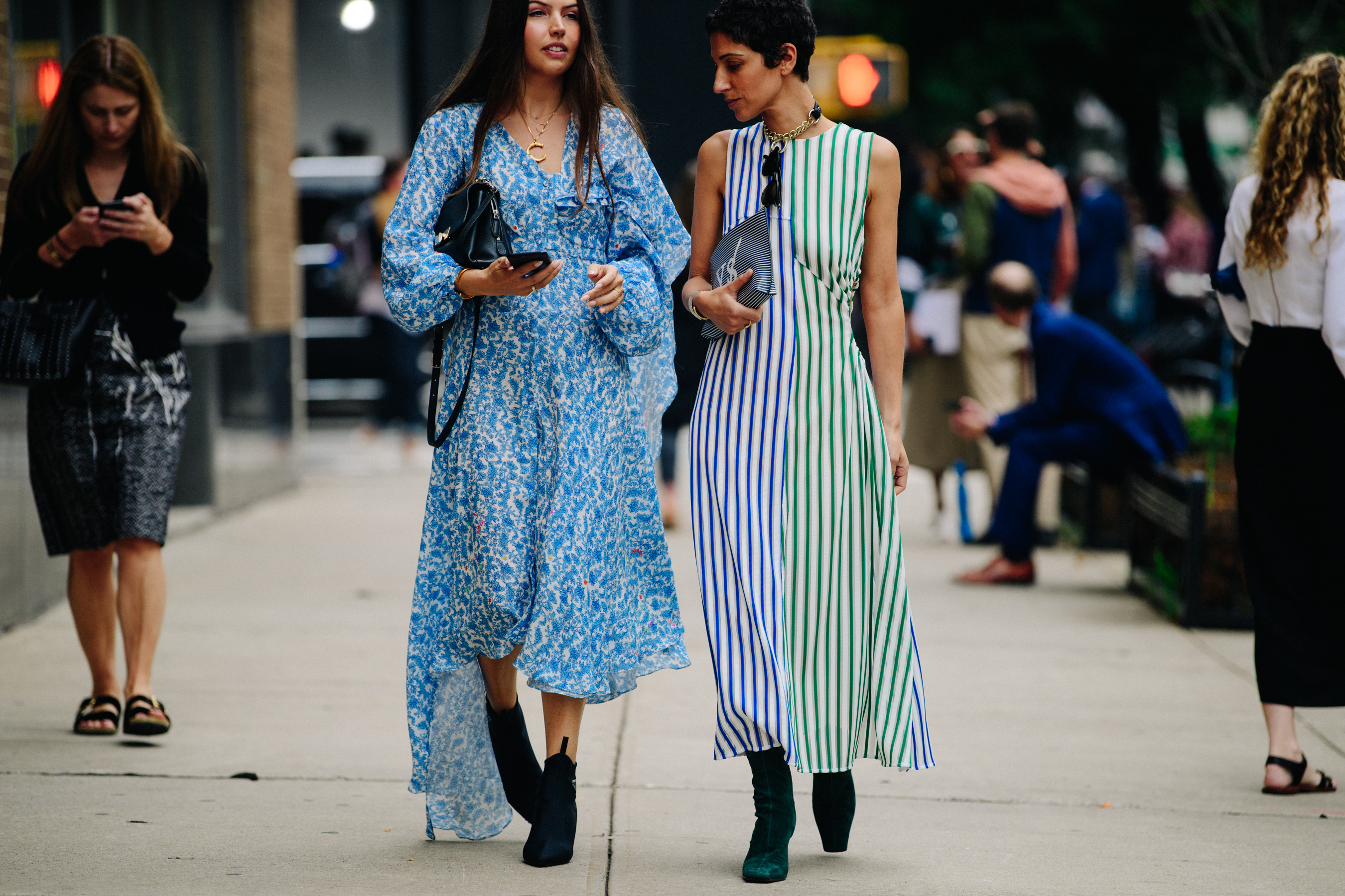 Two women wearing summer dresses