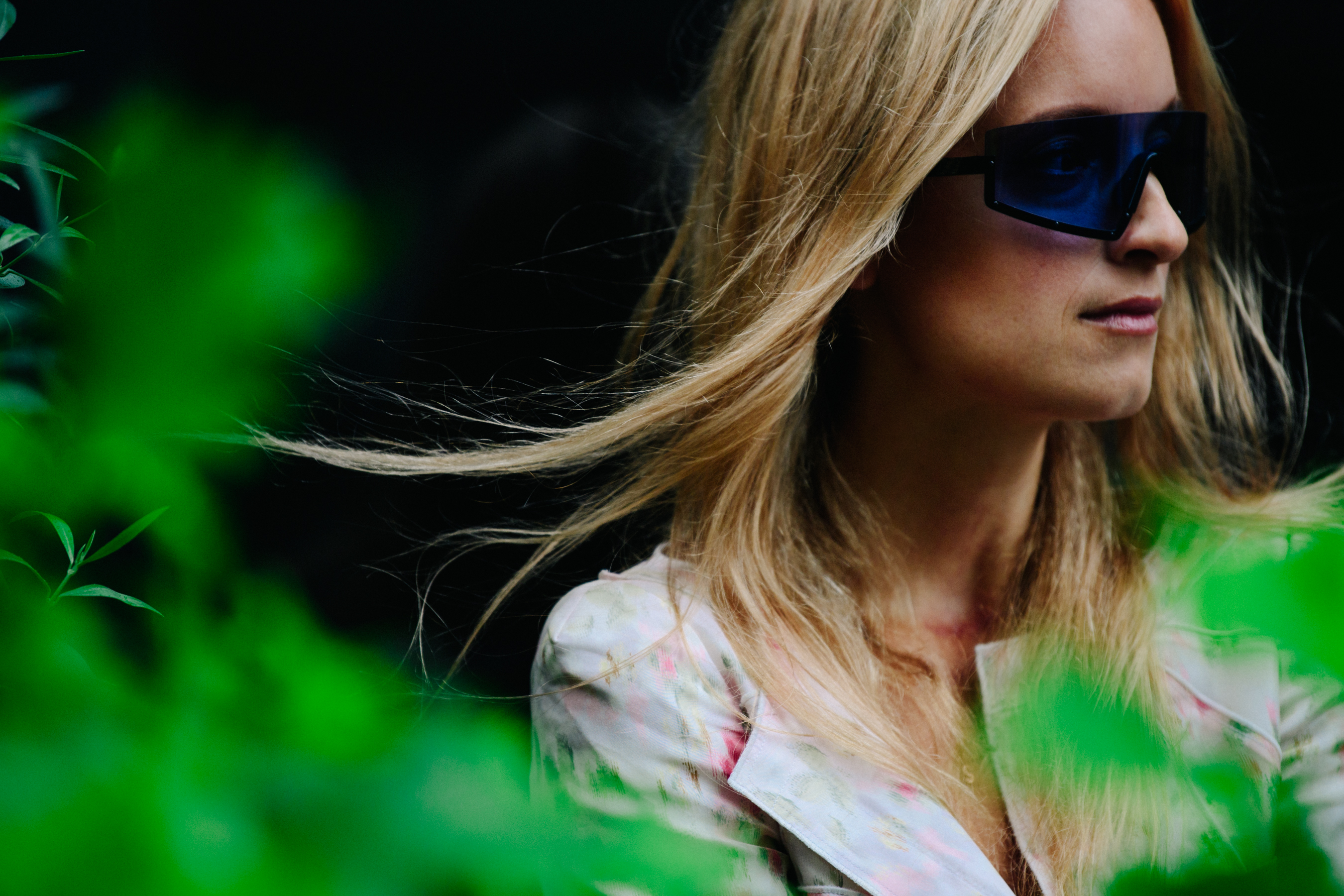 Woman wearing blue sunglasses