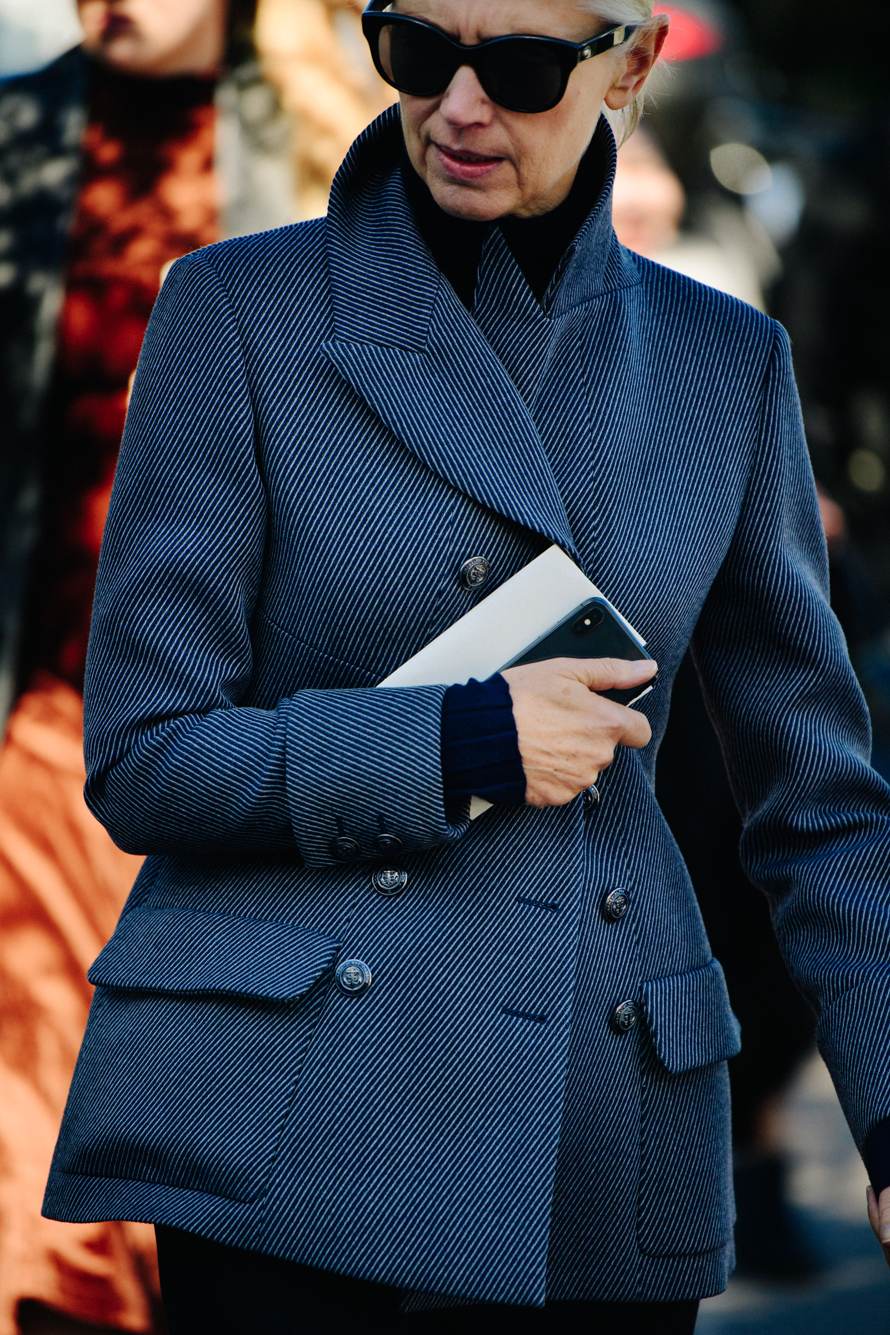Woman wearing striped coat