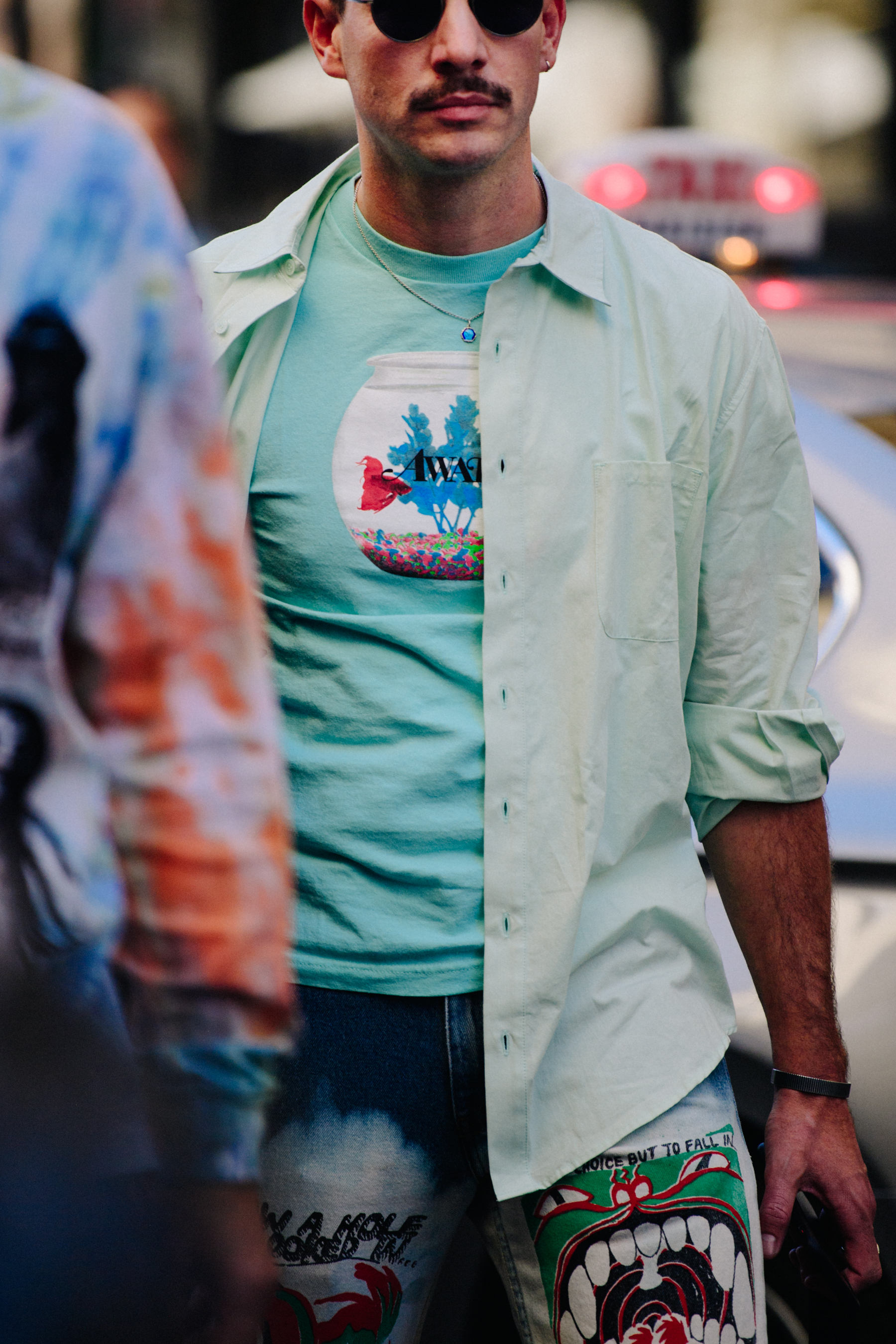 Man wearing turqouise tee shirt