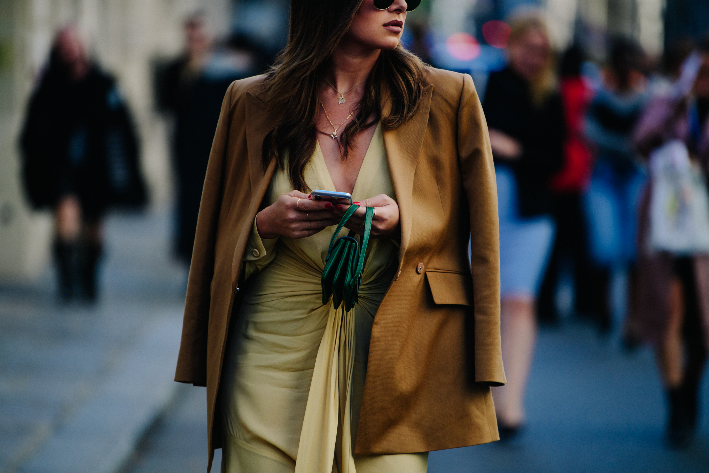 Woman carrying small green bag