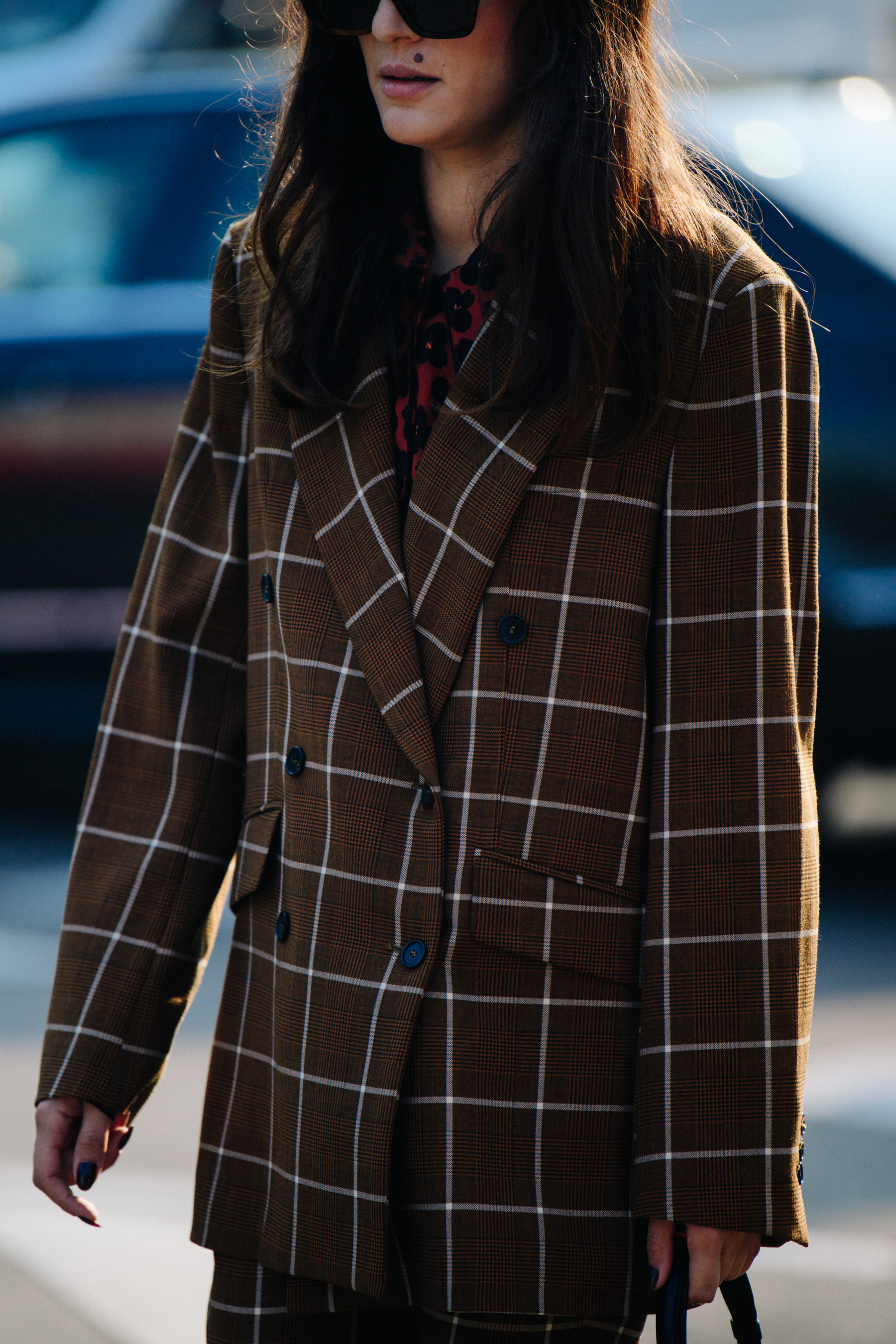 Woman wearing brown check suit