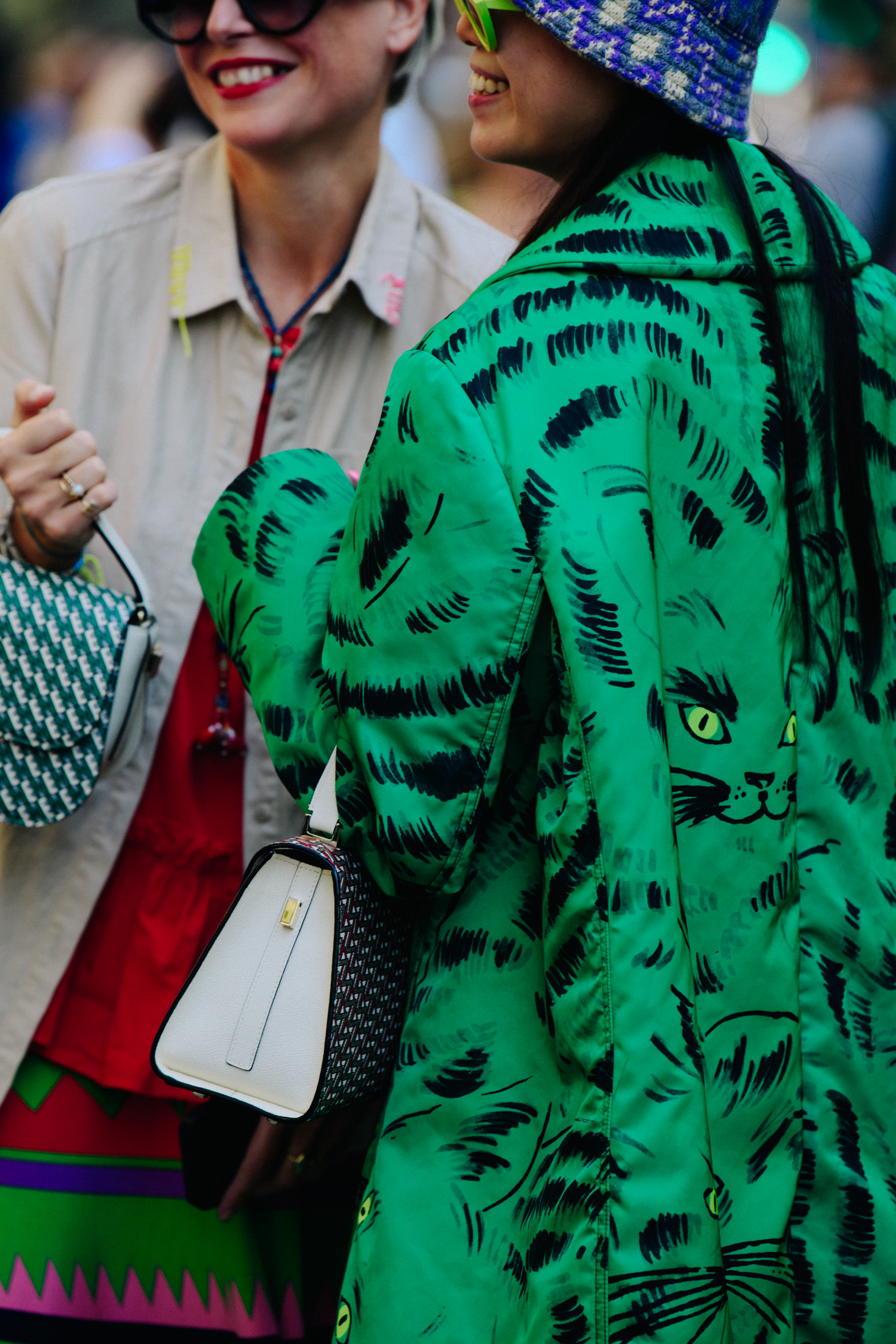 Two women wearing pattern coats and bags