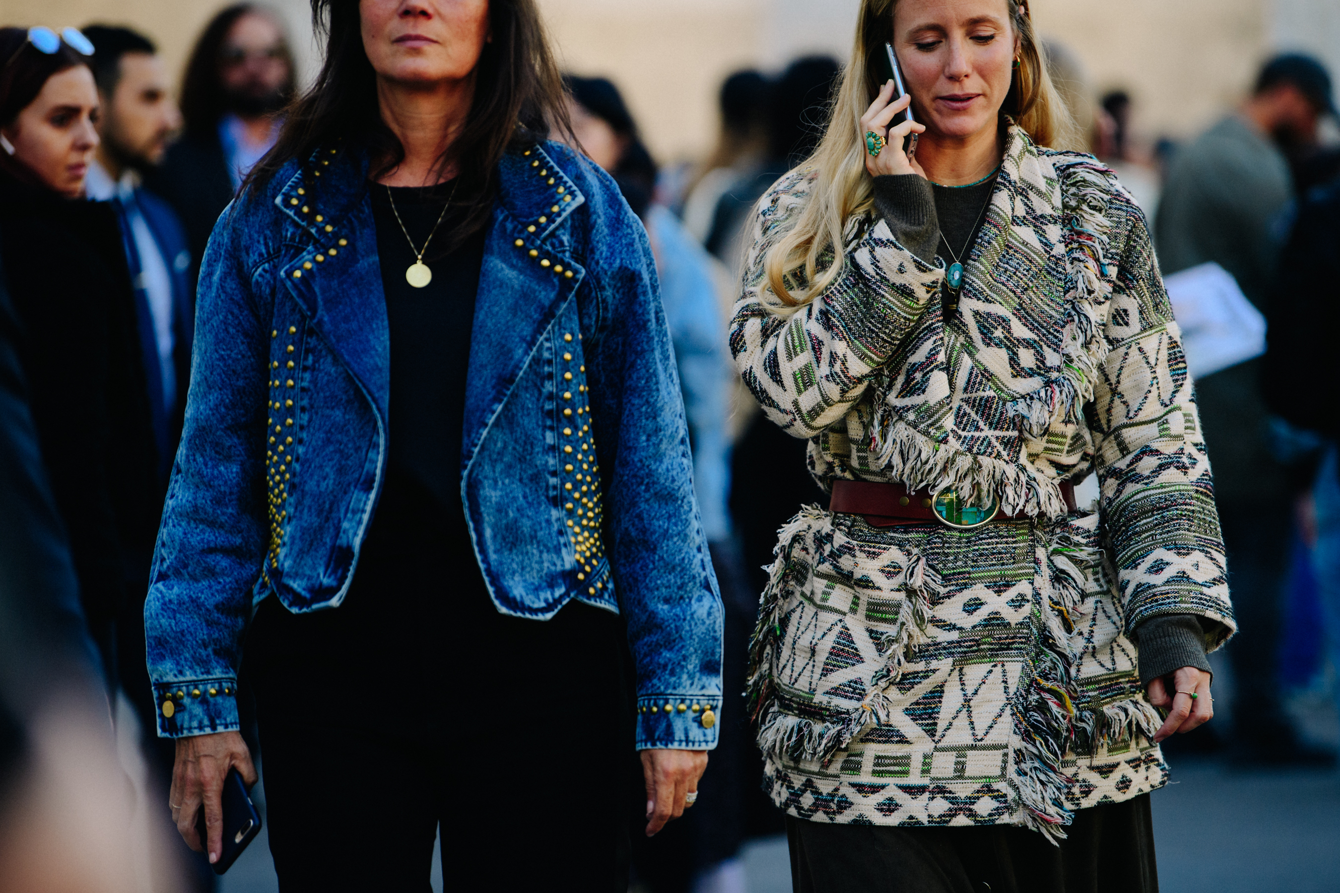 Two women wearing stylish coats