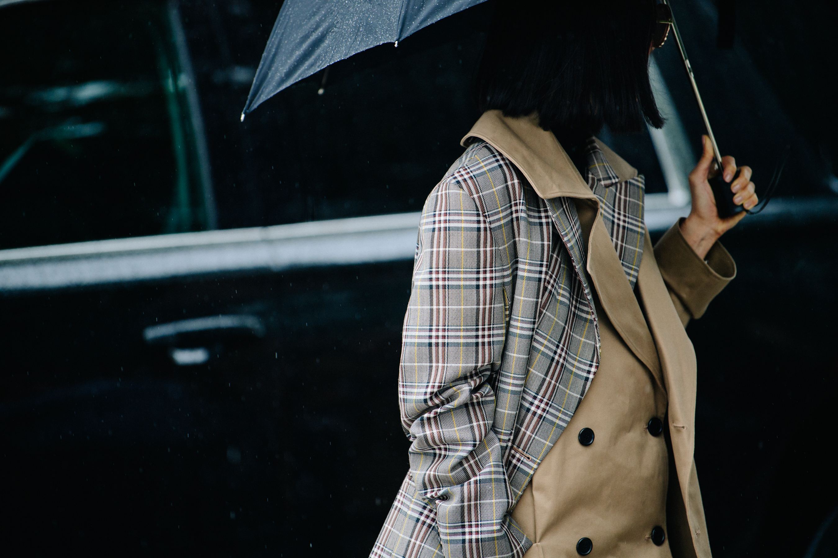 Woman wearing check trench coat