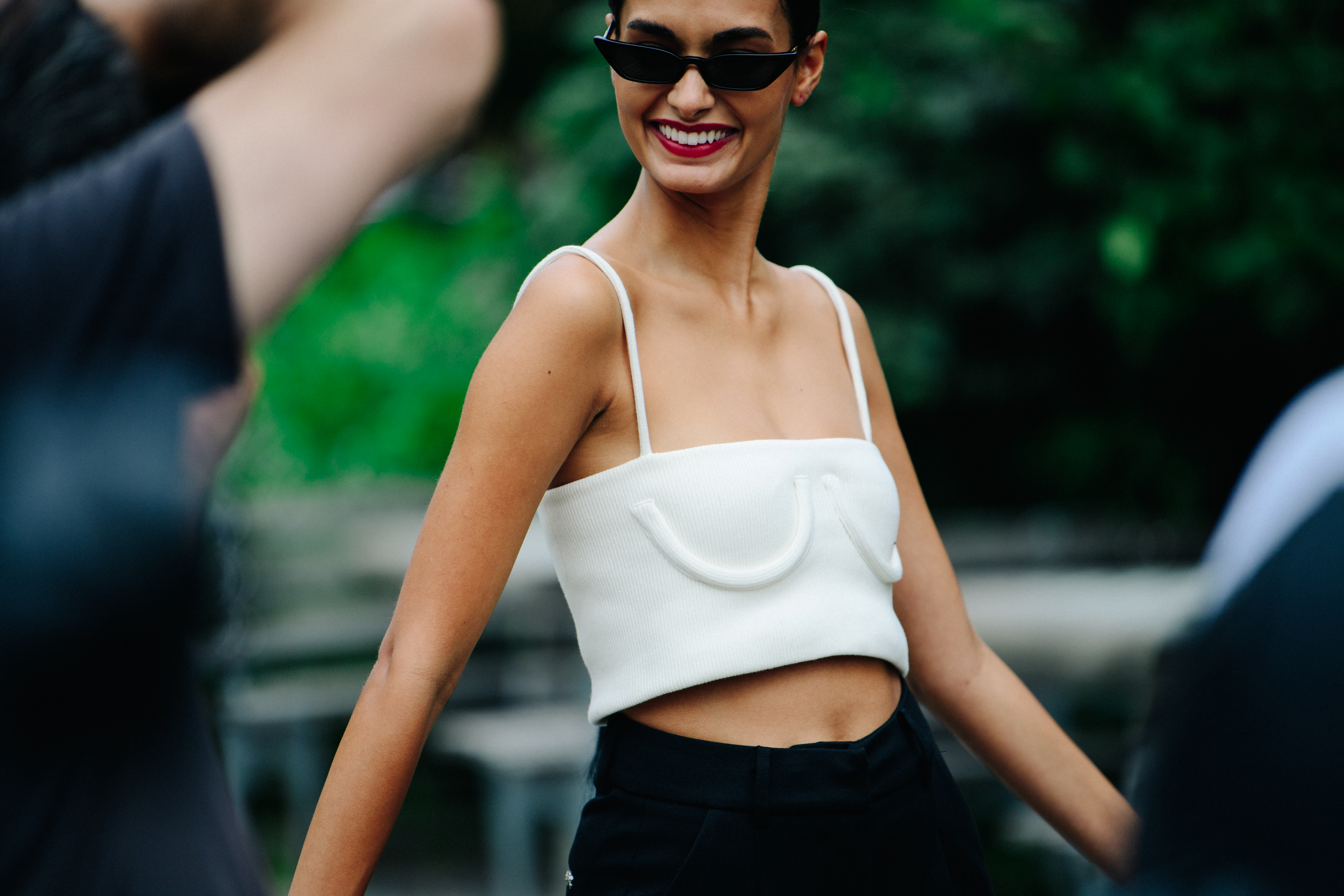 Model wearing white crop top