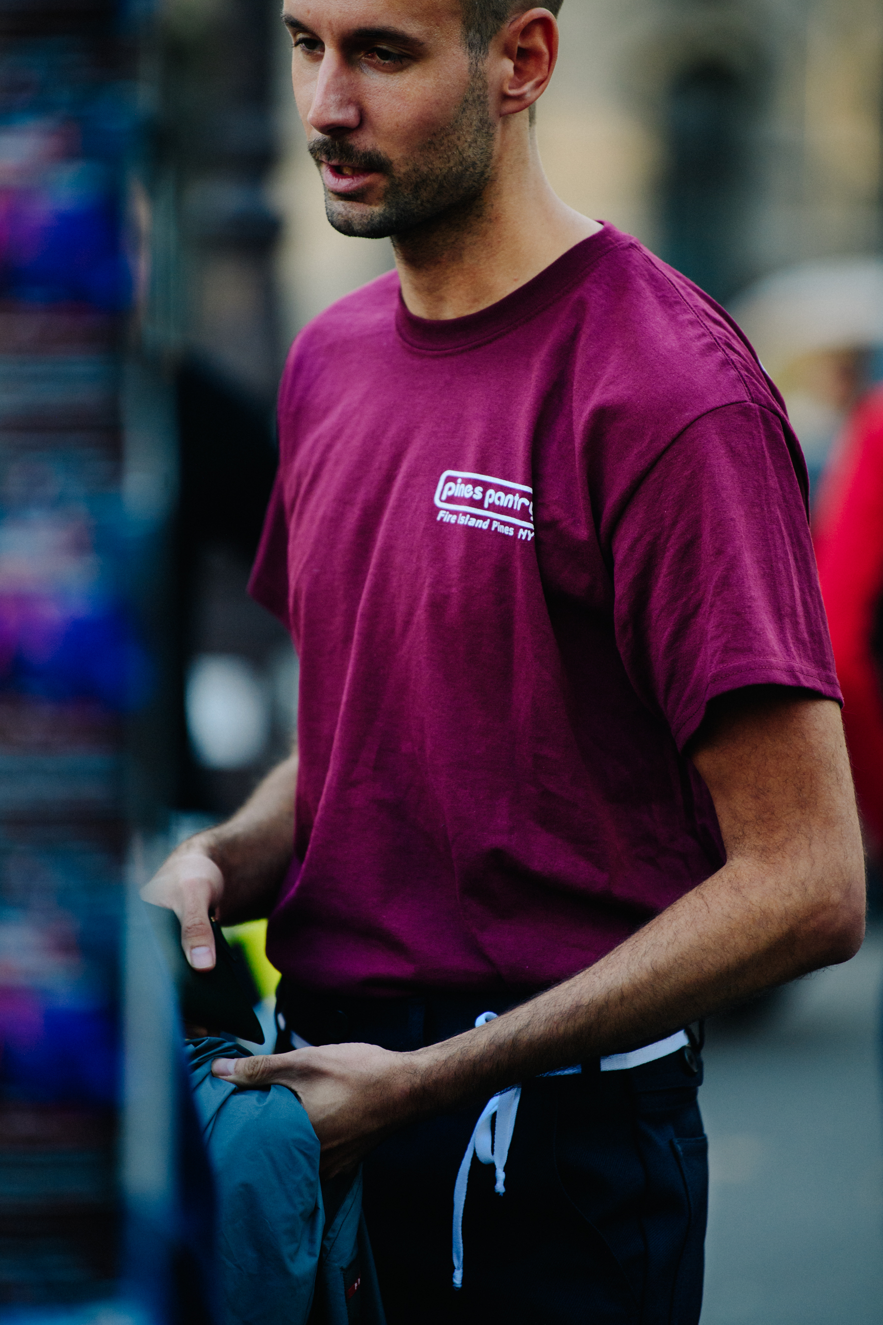 Man wearing burgundy tee shirt