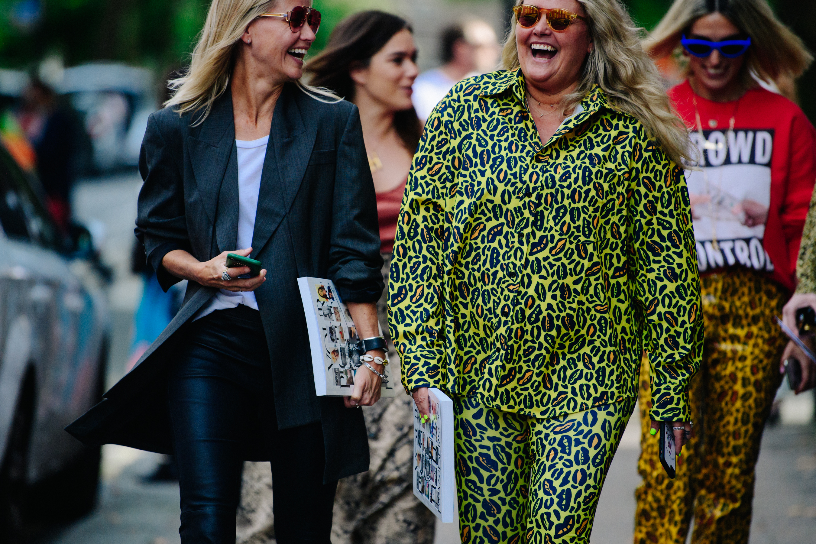 Two women wearing big sunglasses