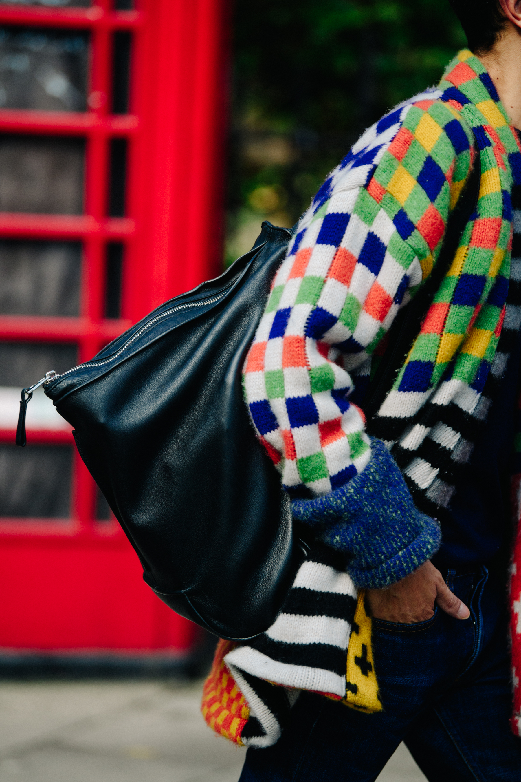 Man wearing multi coloured jumper