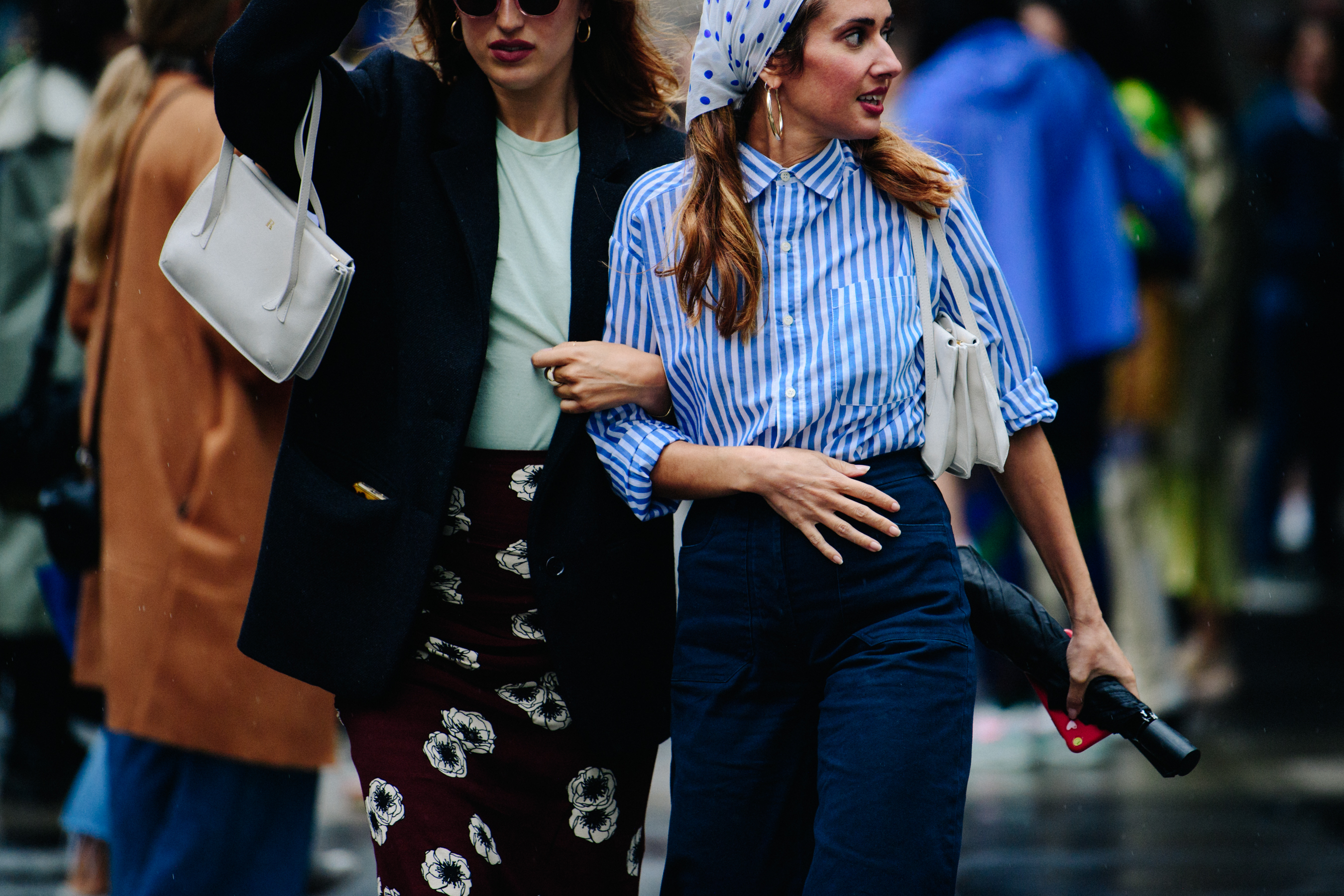 Two women wearing dark blue outfits
