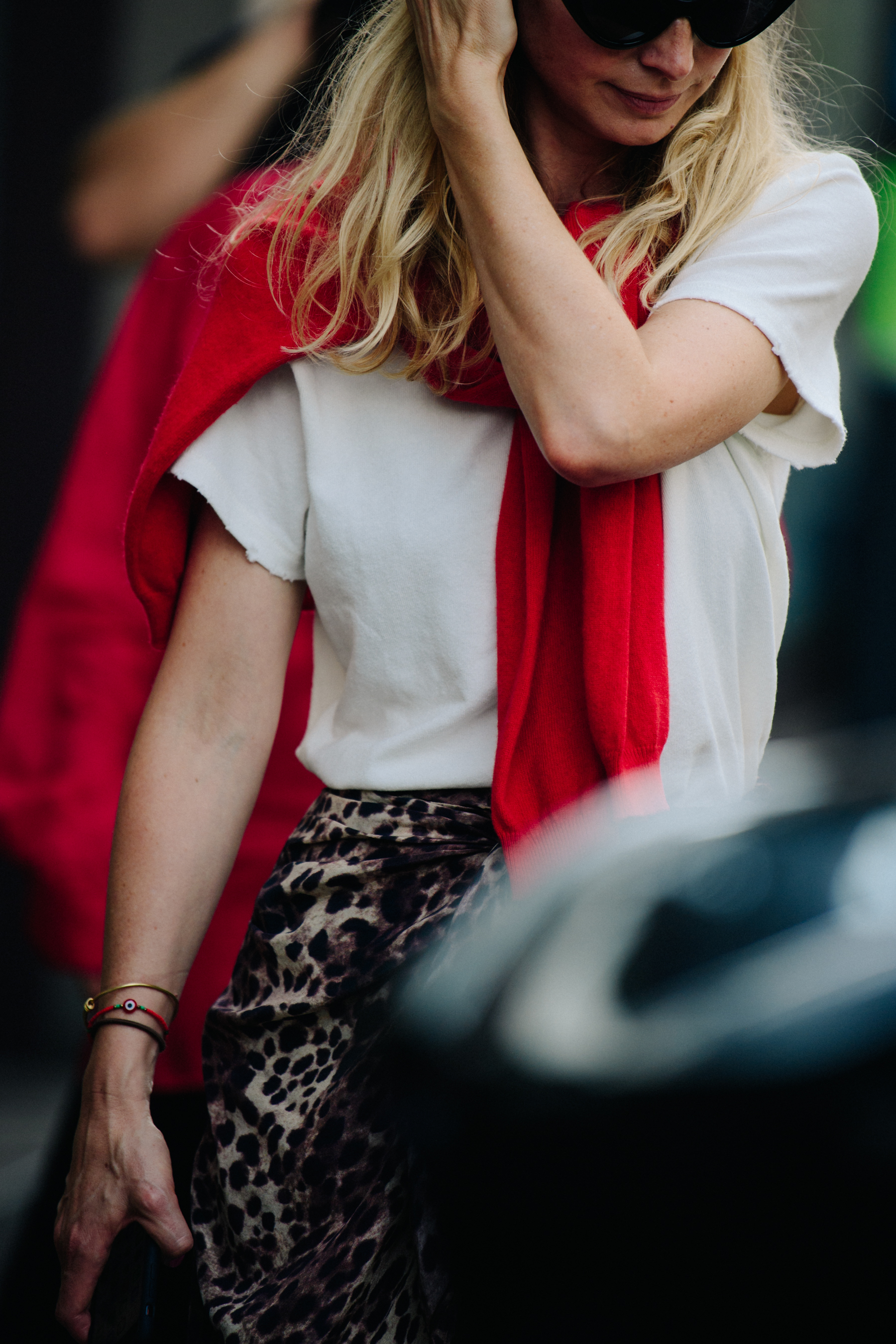 Woman wearing red jumper around neck