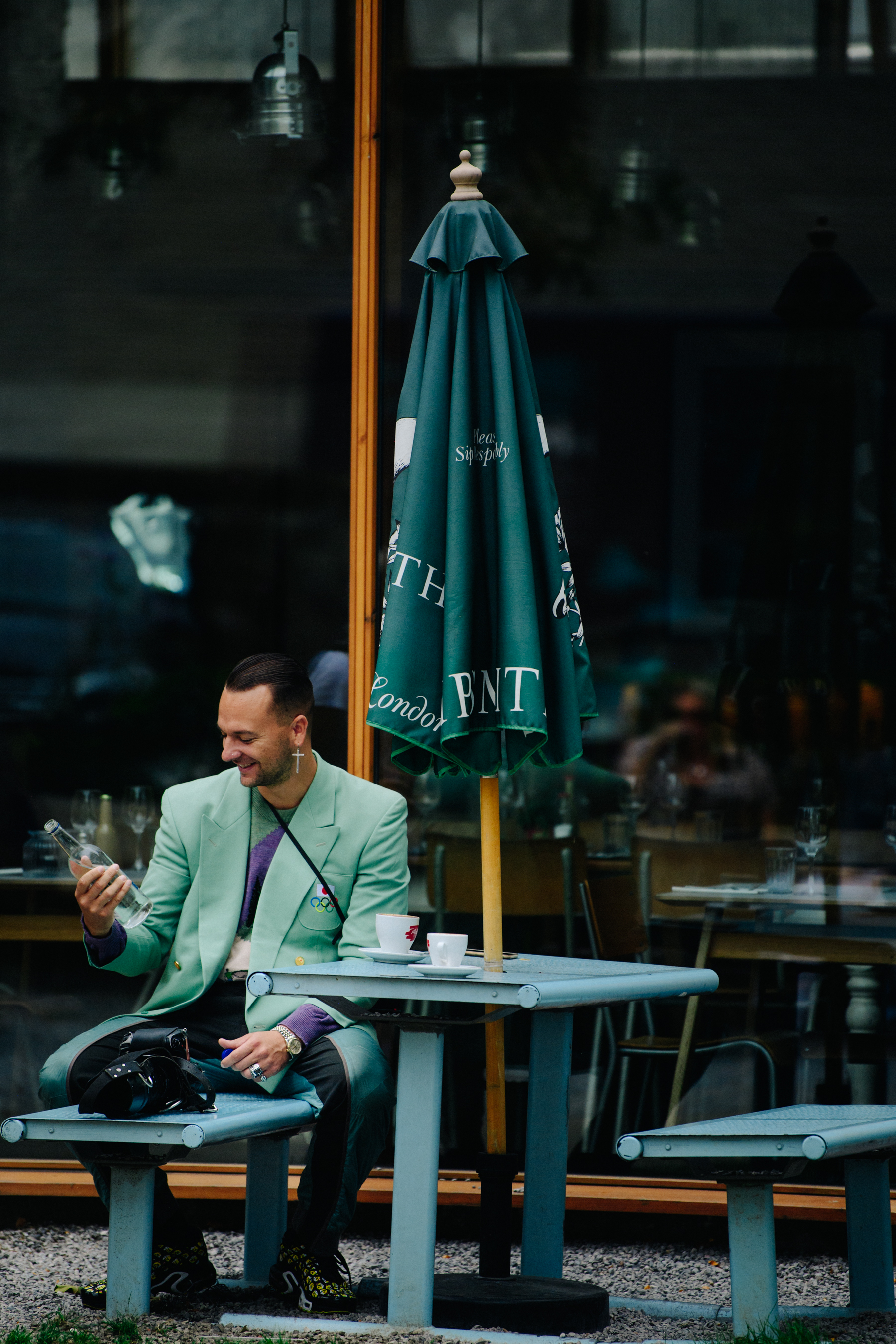 French photographer wearing green suit jacket
