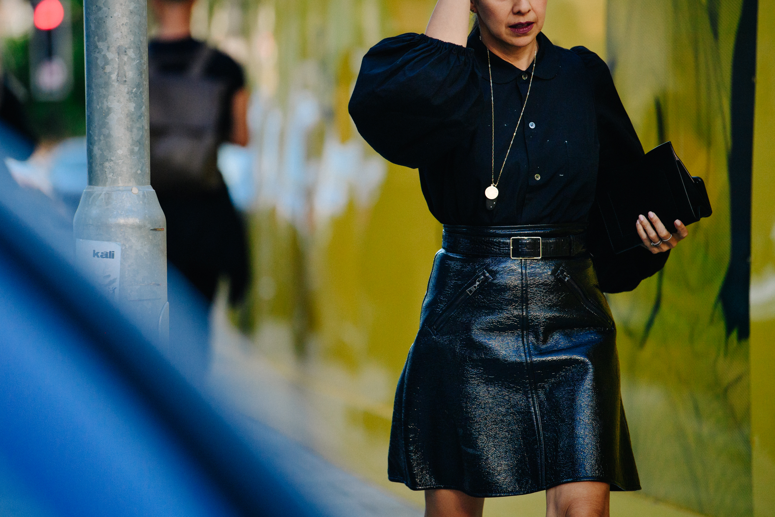 Woman wearing black plastic skirt