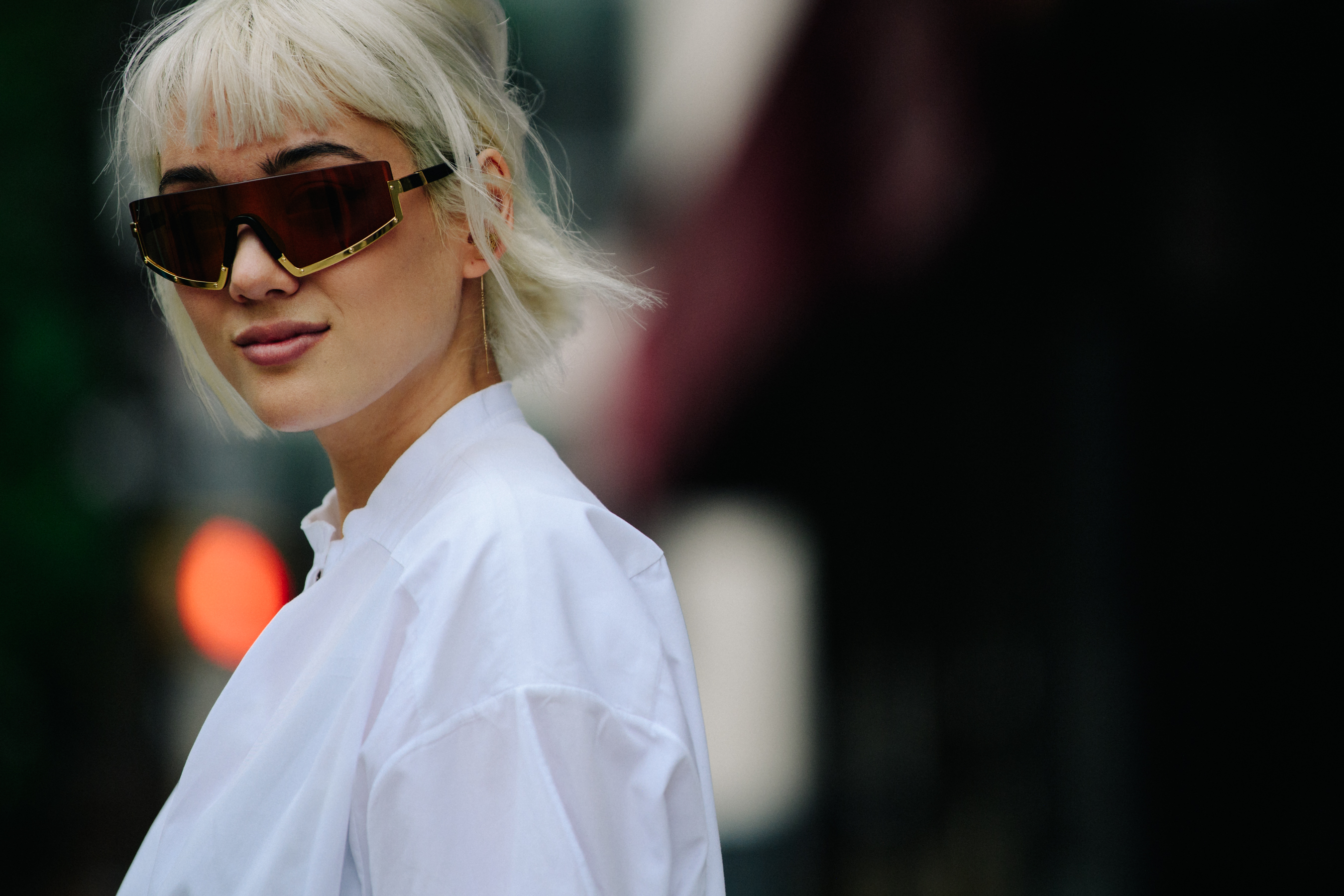 Woman wearing gold rim sunglasses