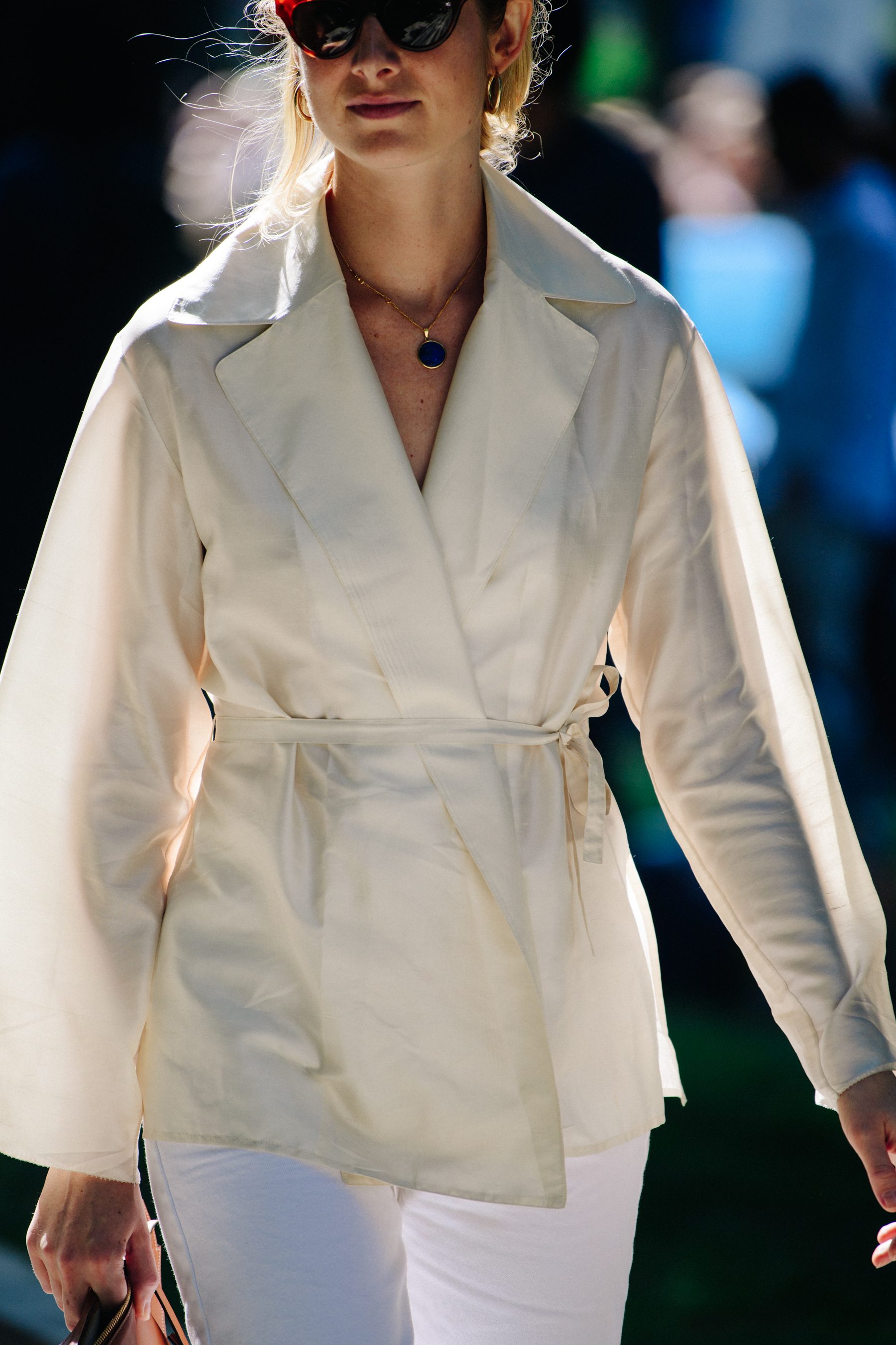 Woman wearing white belted shirt
