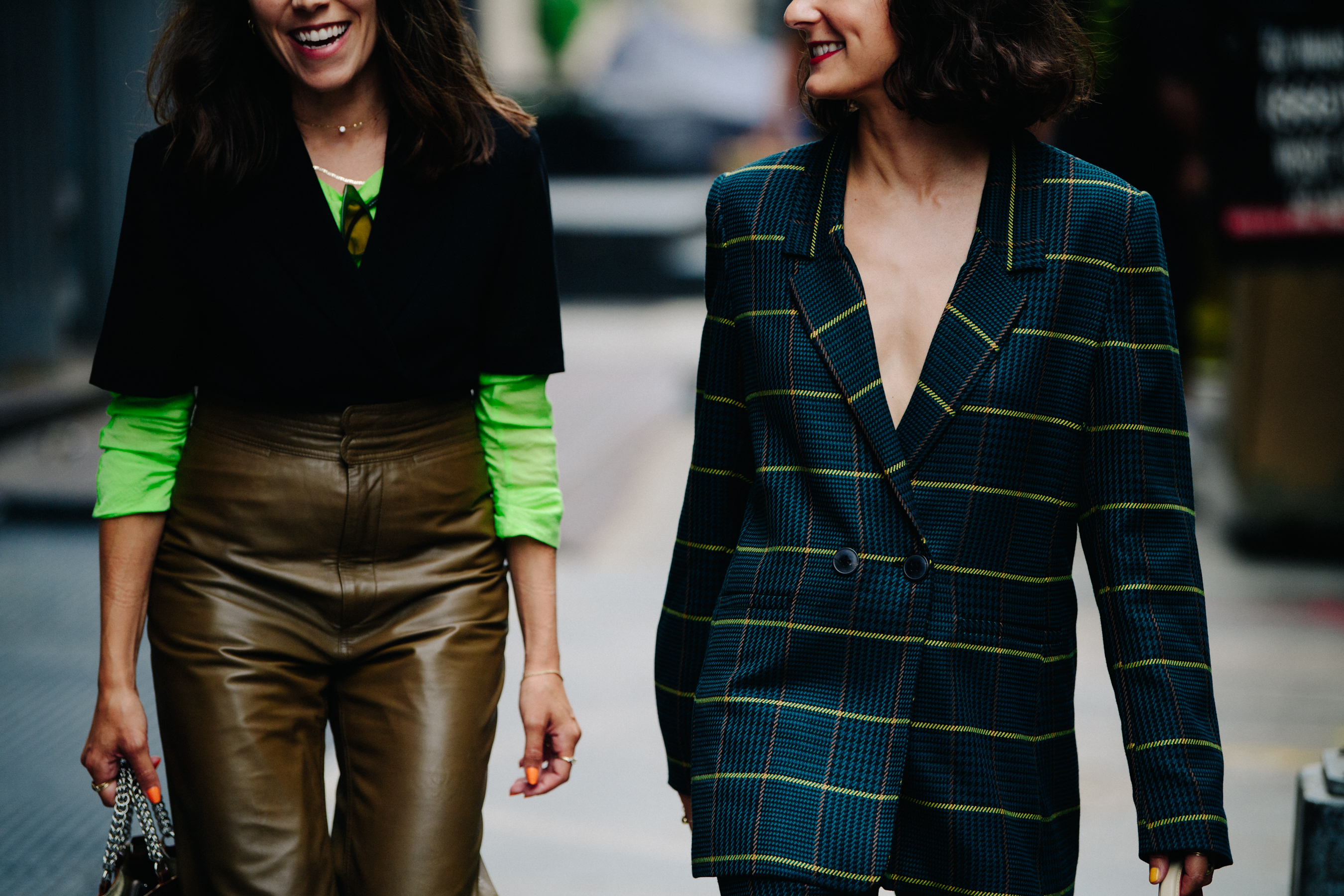 Two women wearing green and blue