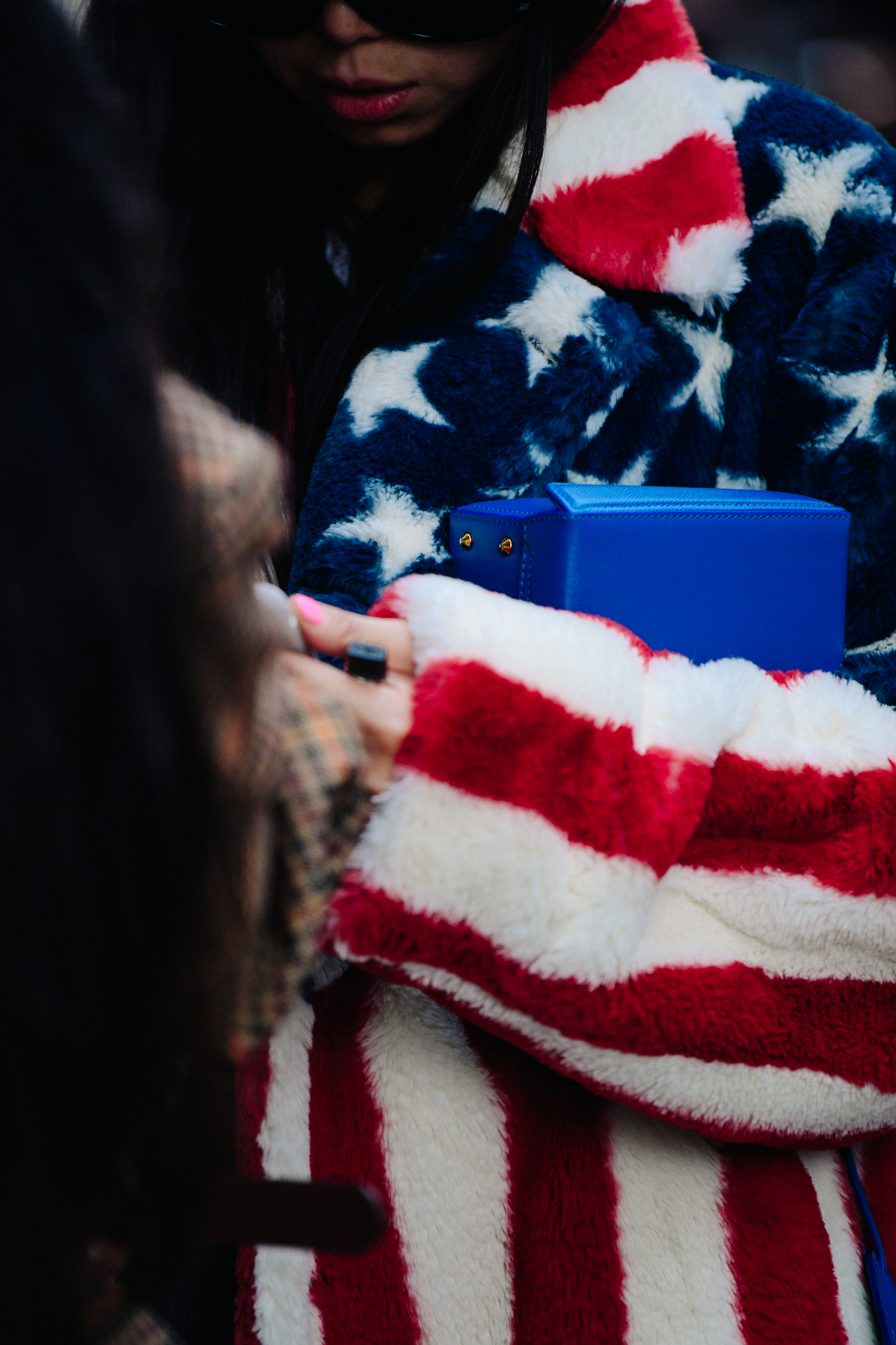 Asian woman wearing American flag fur coat