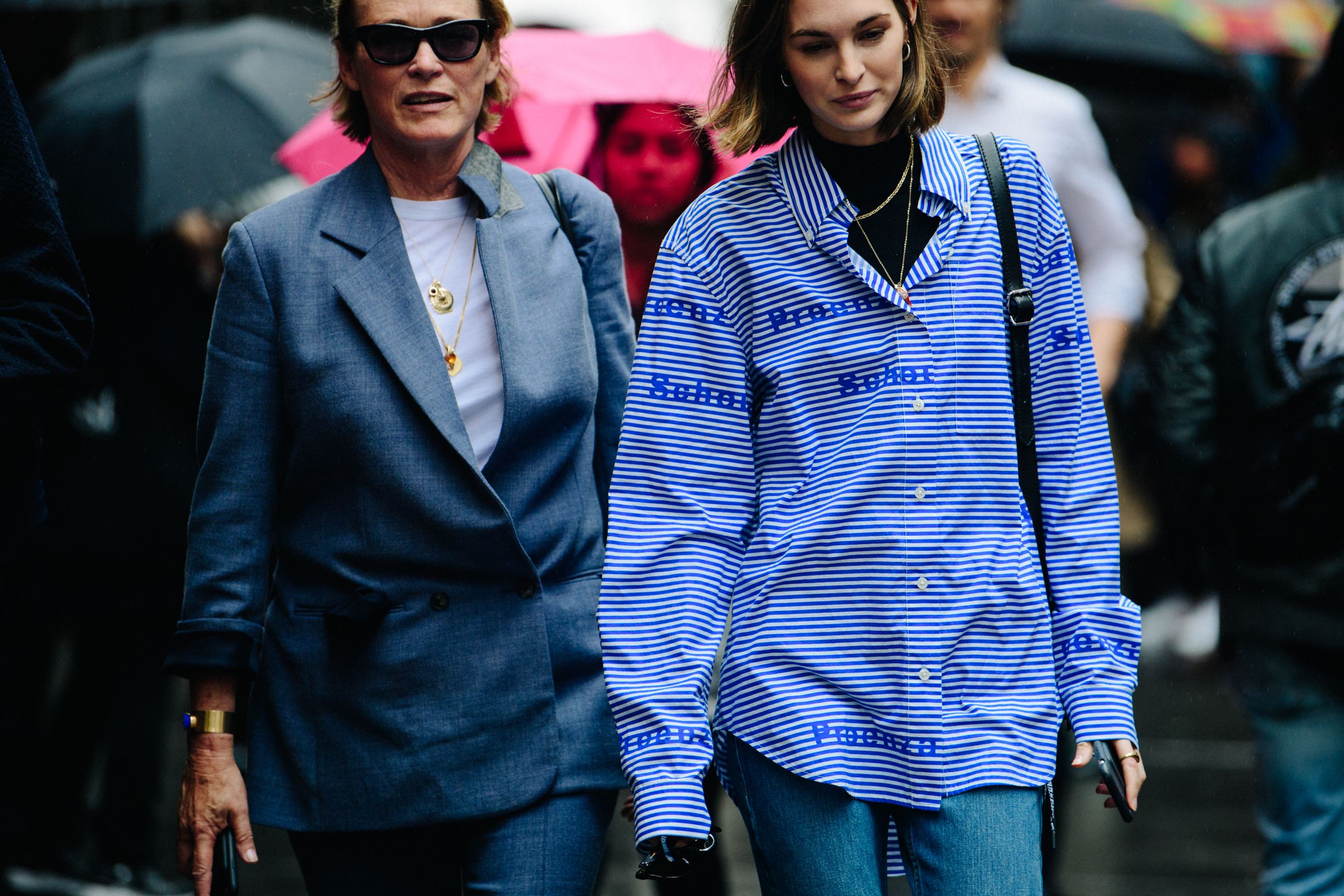 Two women wearing blue