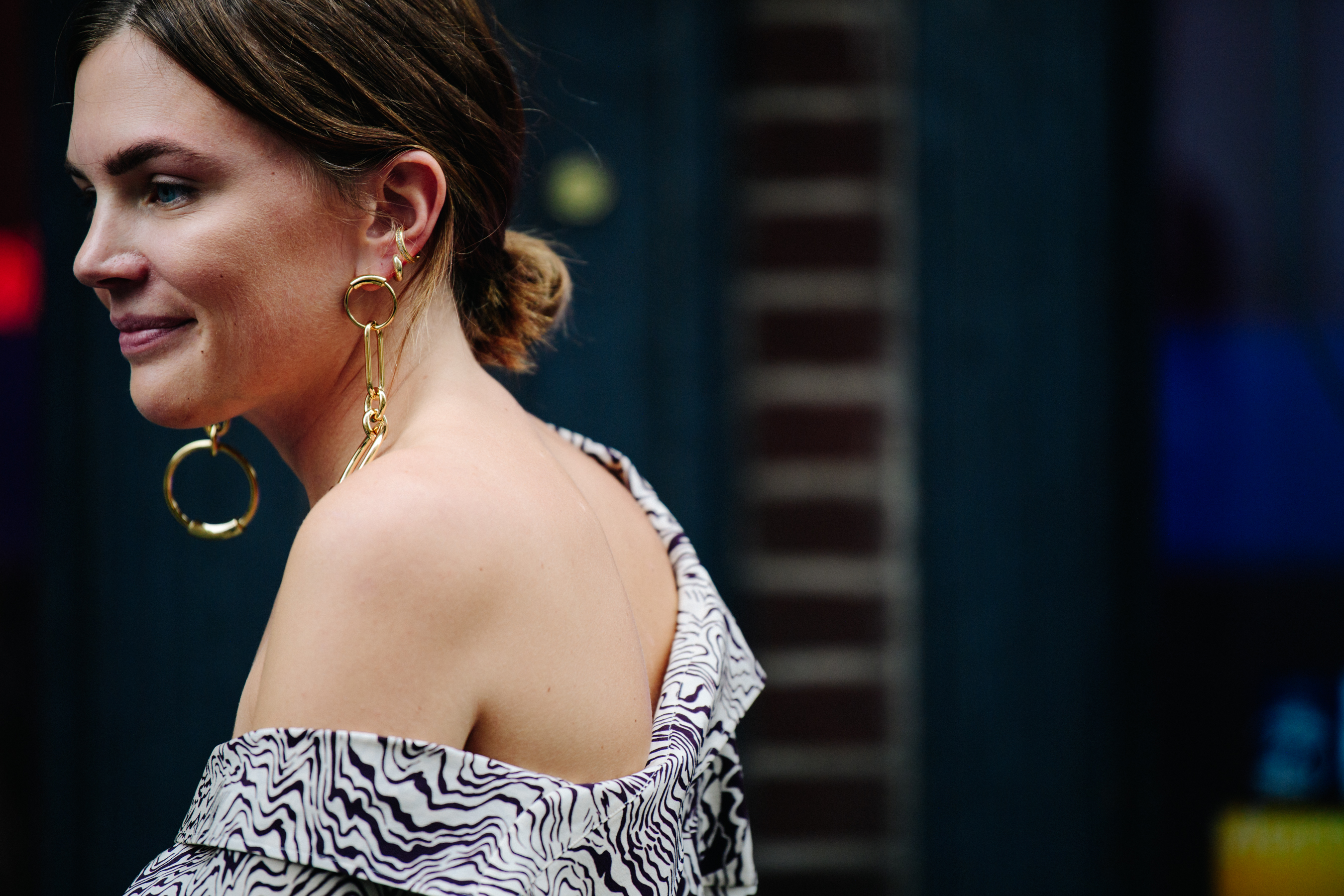 Woman wearing long gold earrings