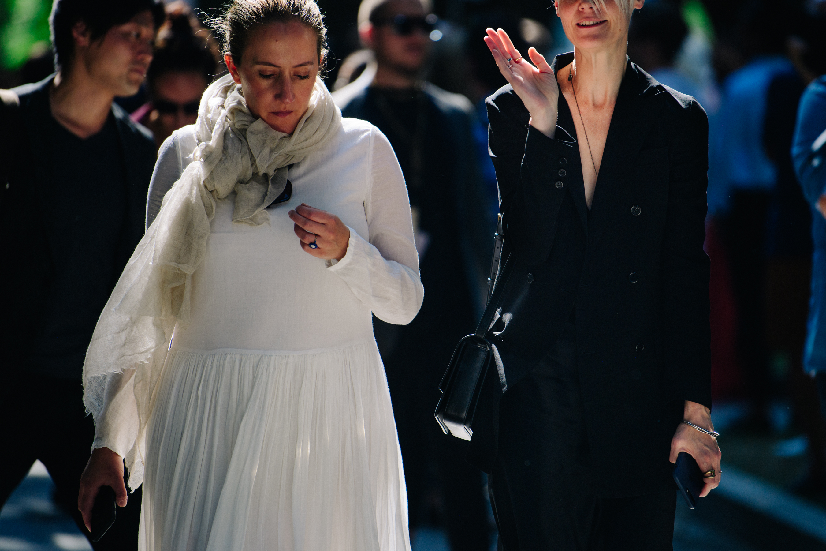 Two women wearing white and black