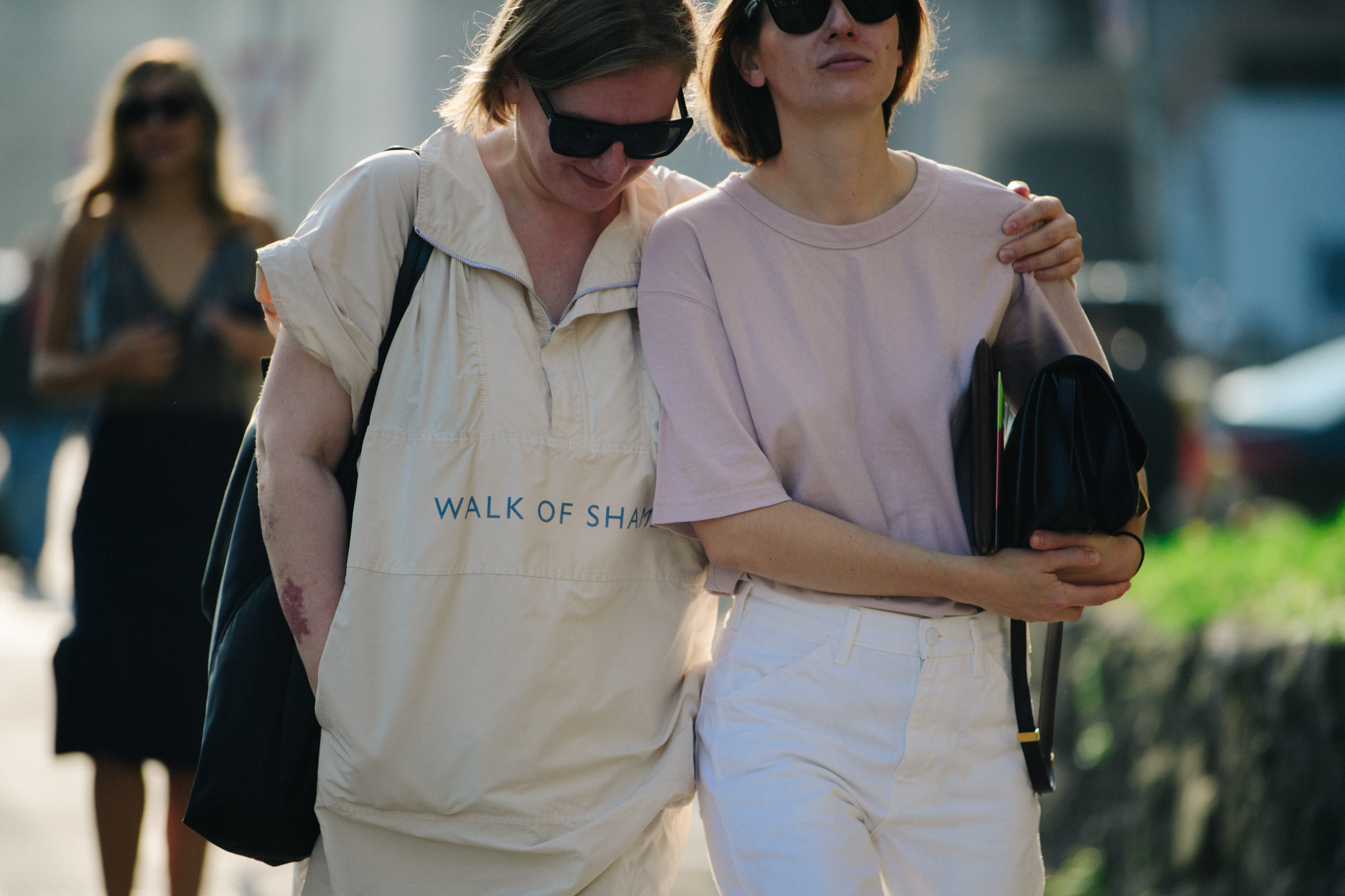 Two women wearing muted colours