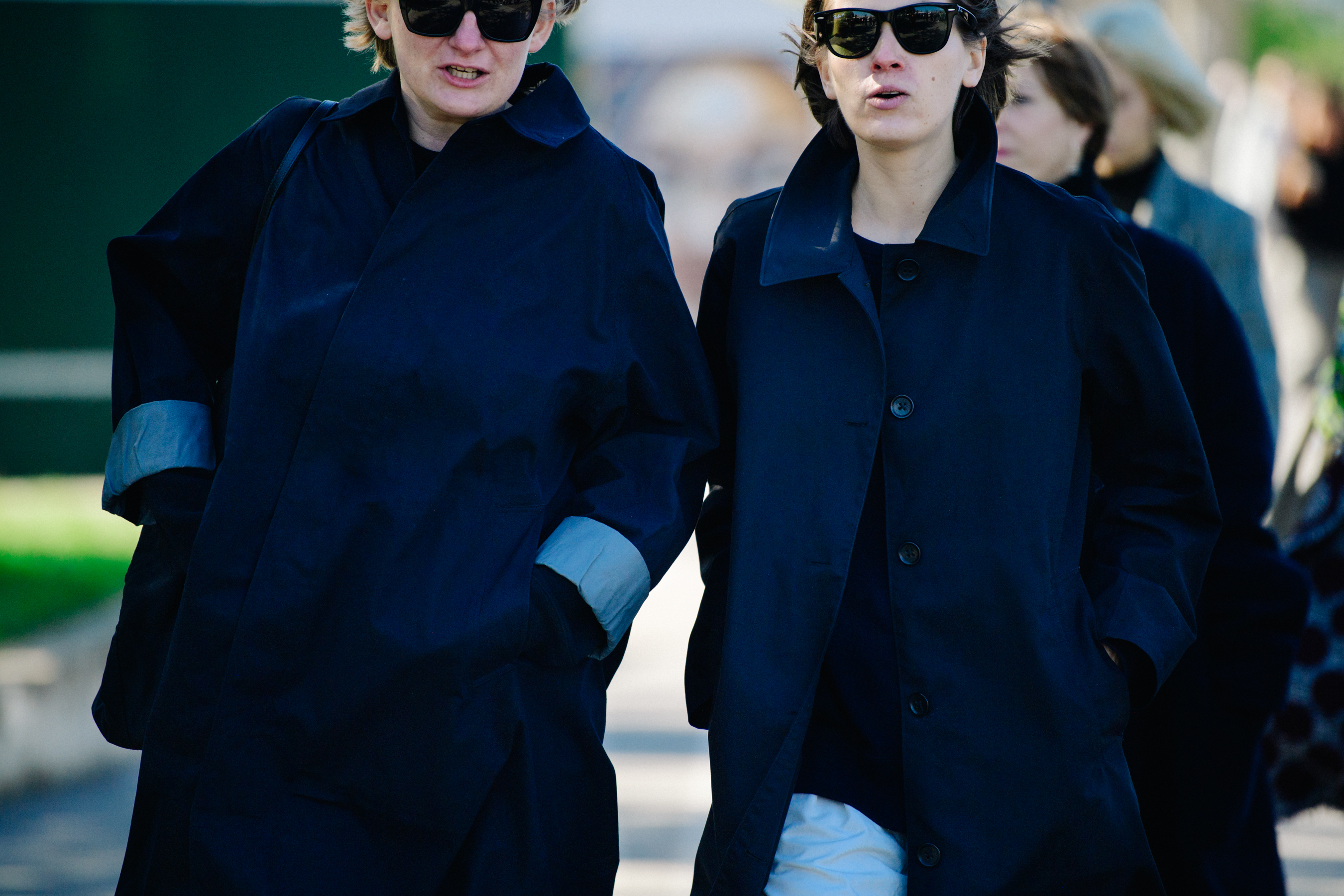 Two women wearing dark coats