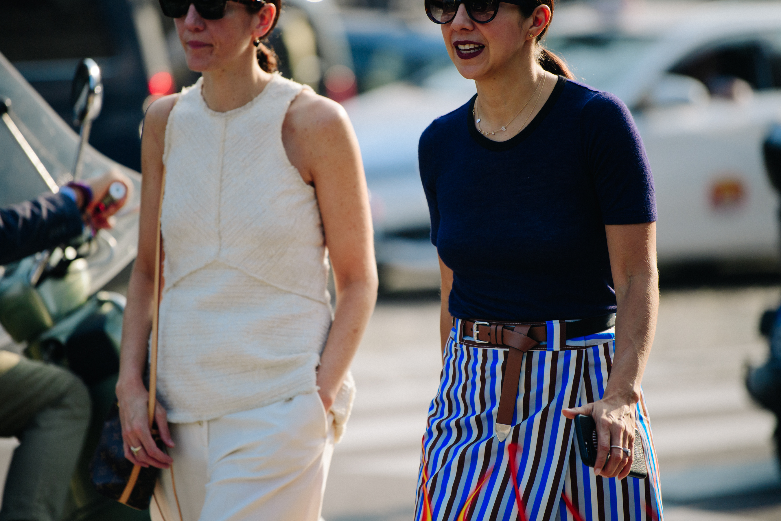 Two women wearing light tops