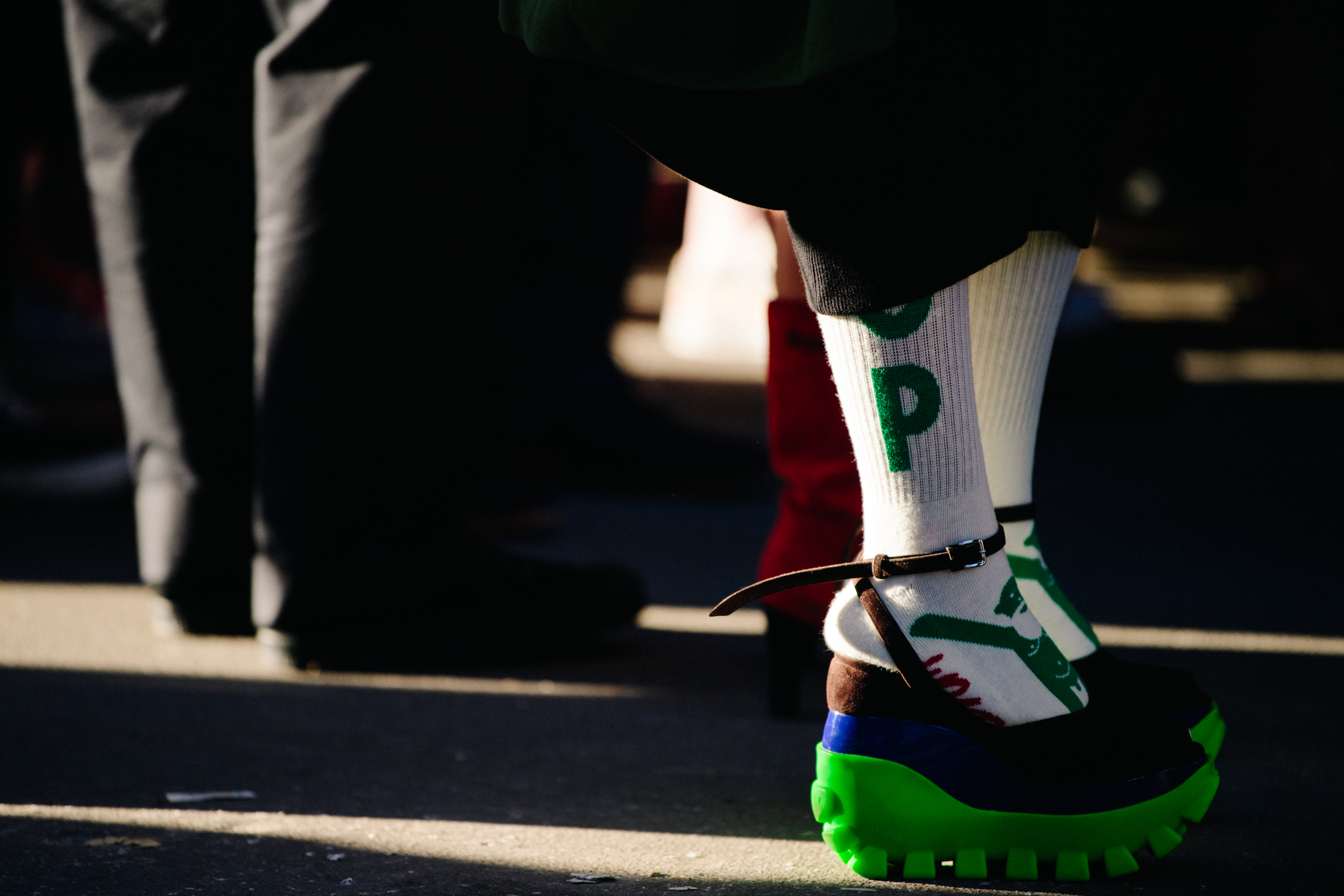 Woman wearing green and brown shoes