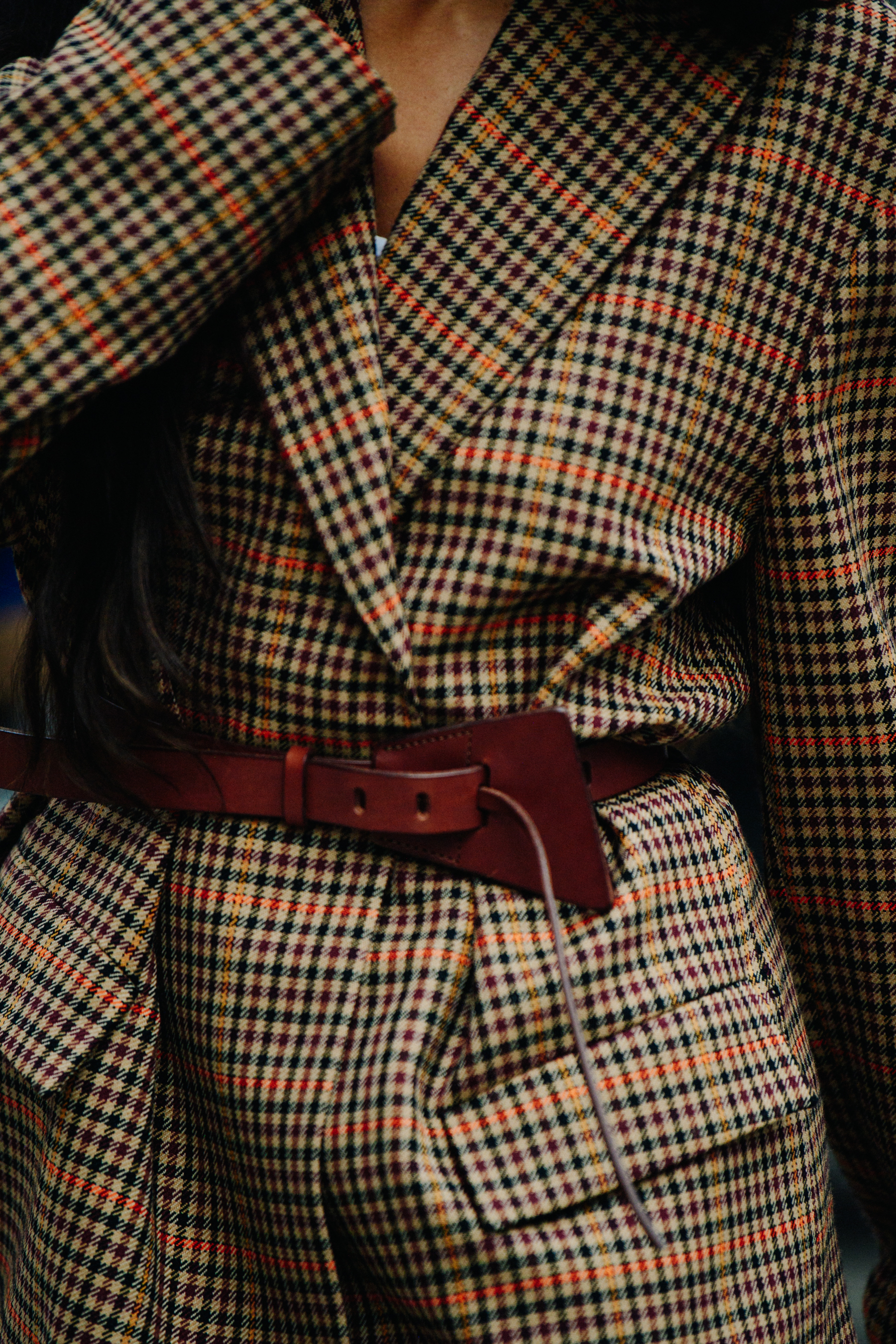 Woman wearing brown check jacket