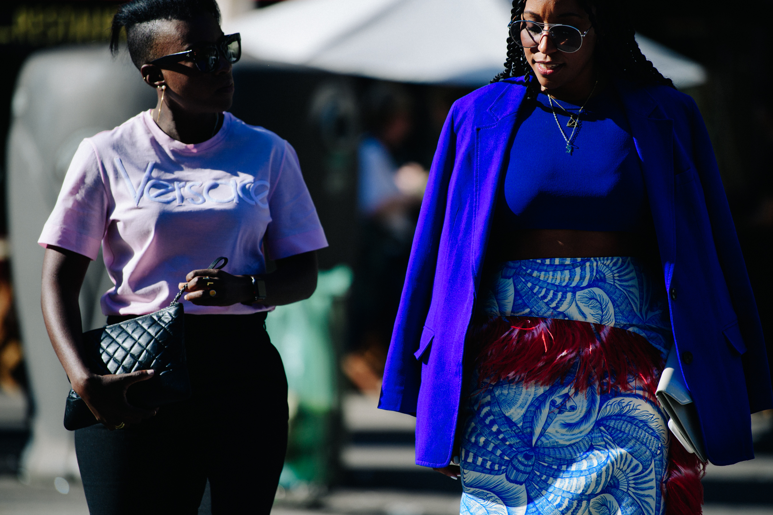 Two women wearing light colour outfits