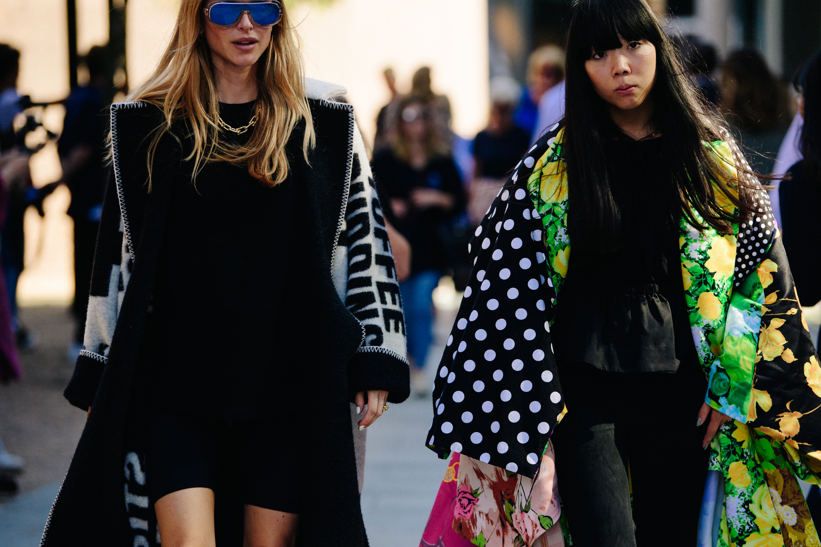 Two women wearing dark outfits