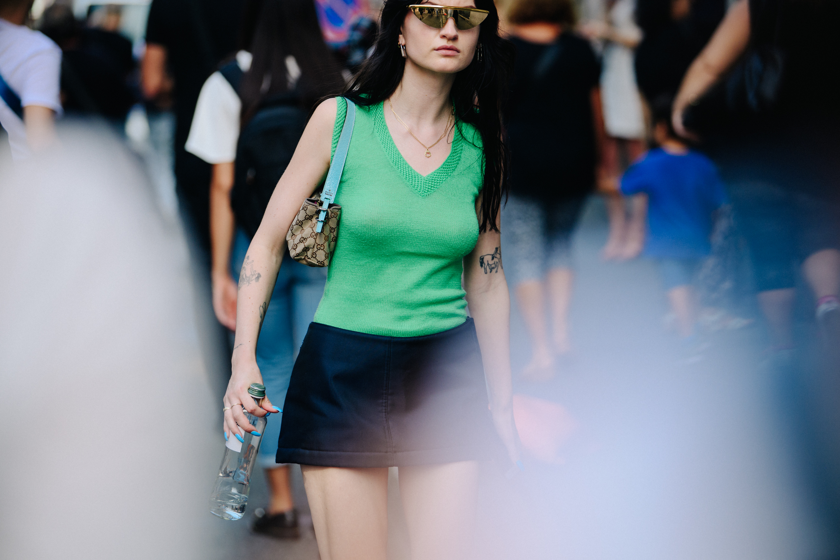 Woman wearing green sleeveless top