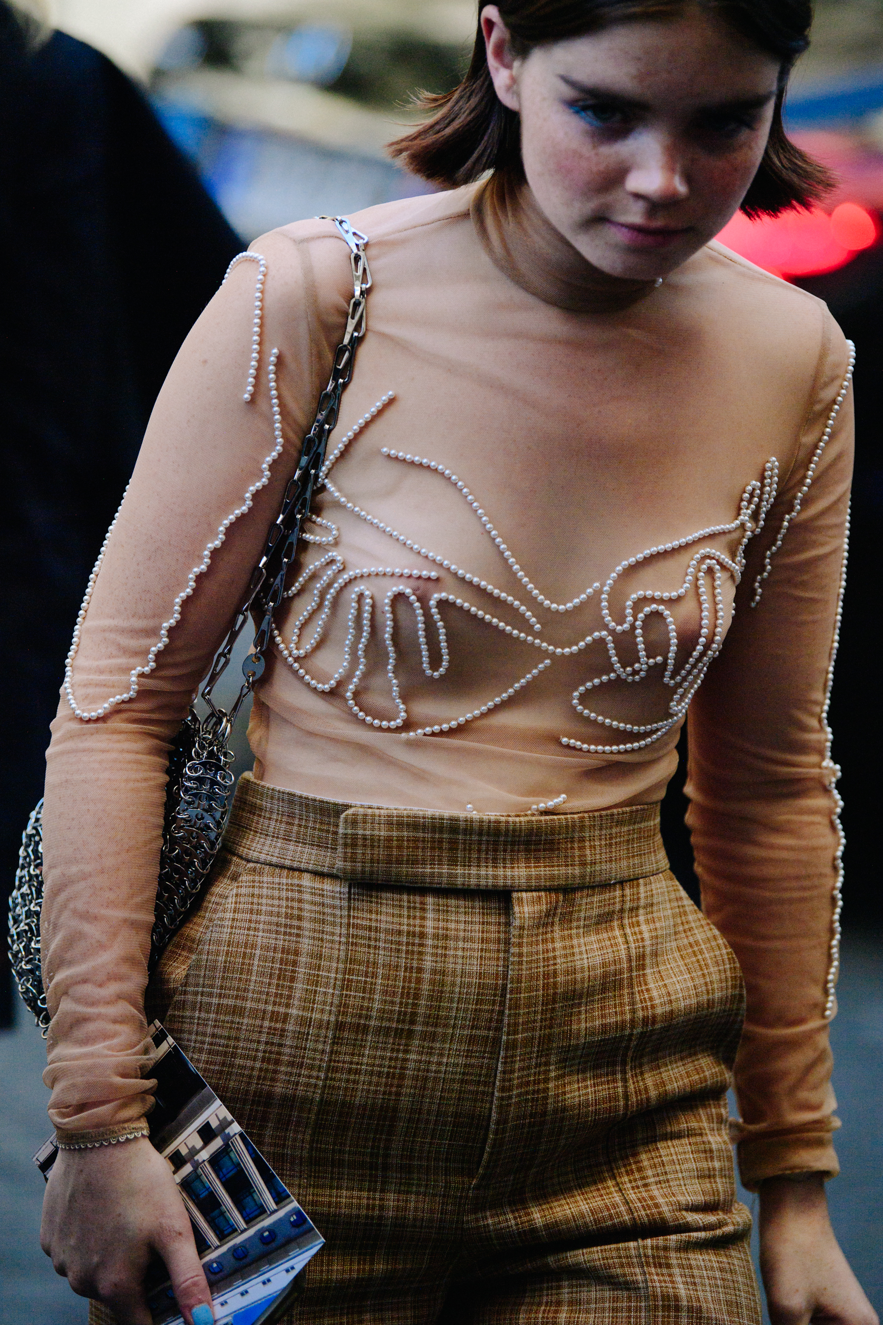 Woman wearing top with pearls