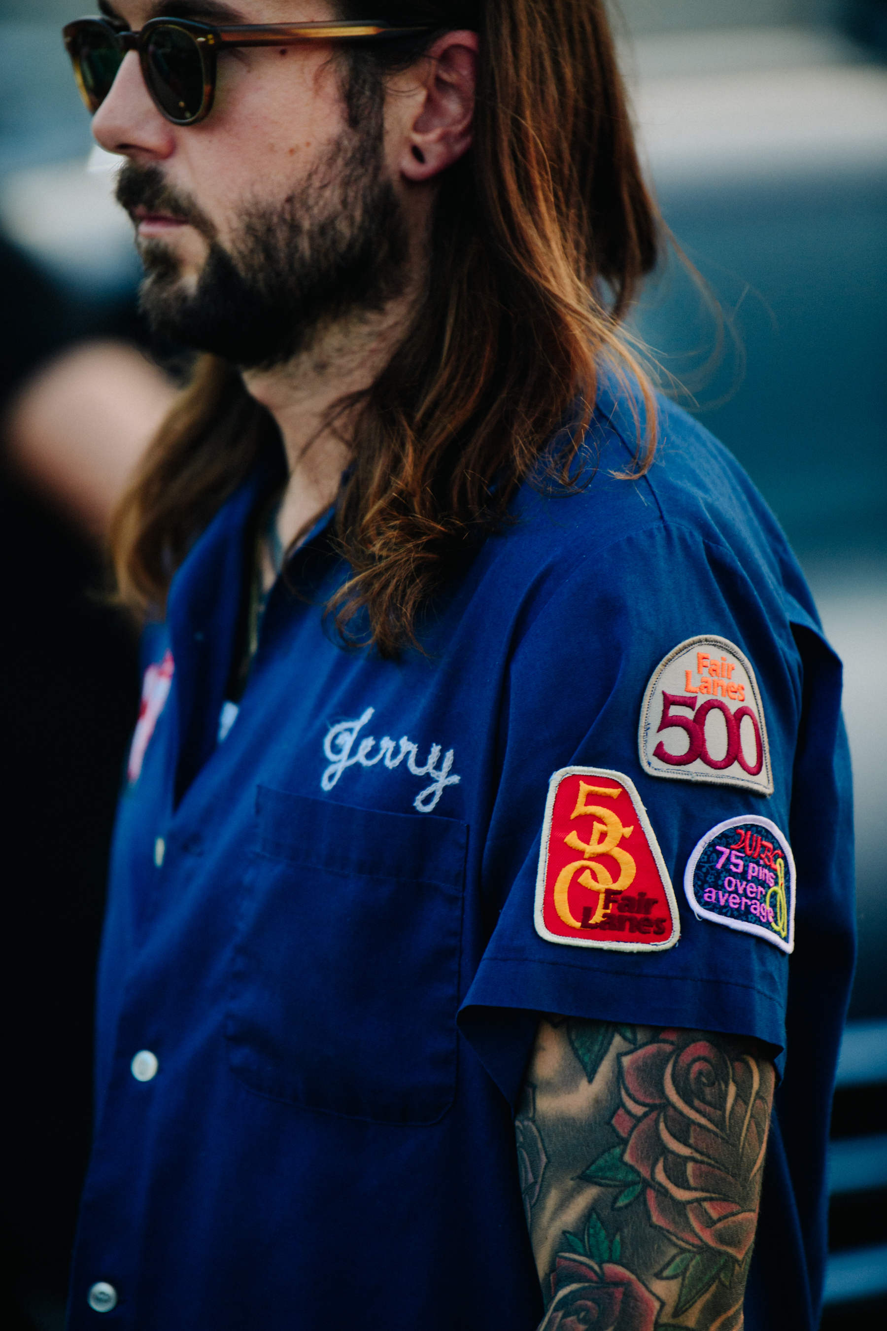 Man wearing blue bowling shirt