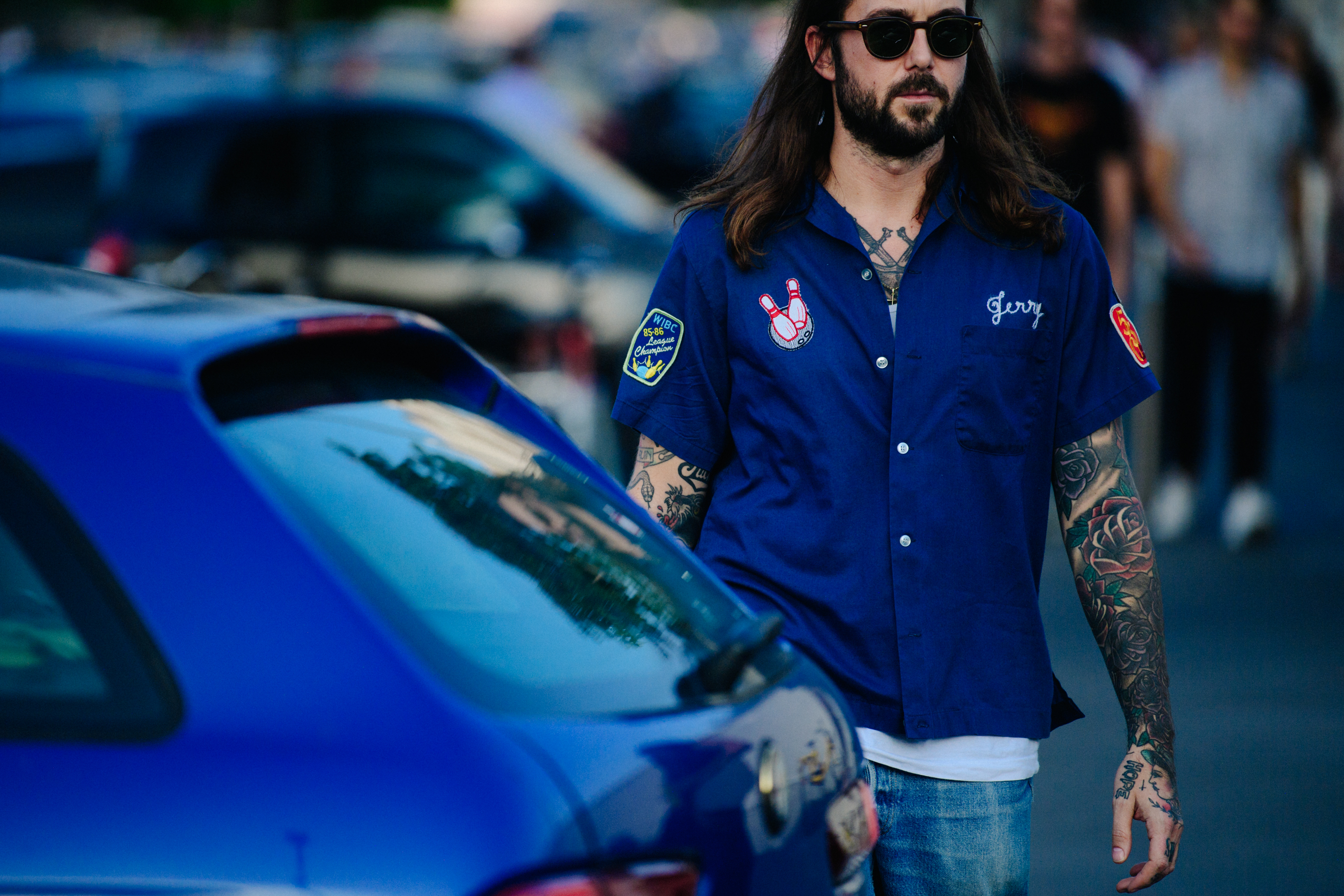 Man wearing blue bowling shirt
