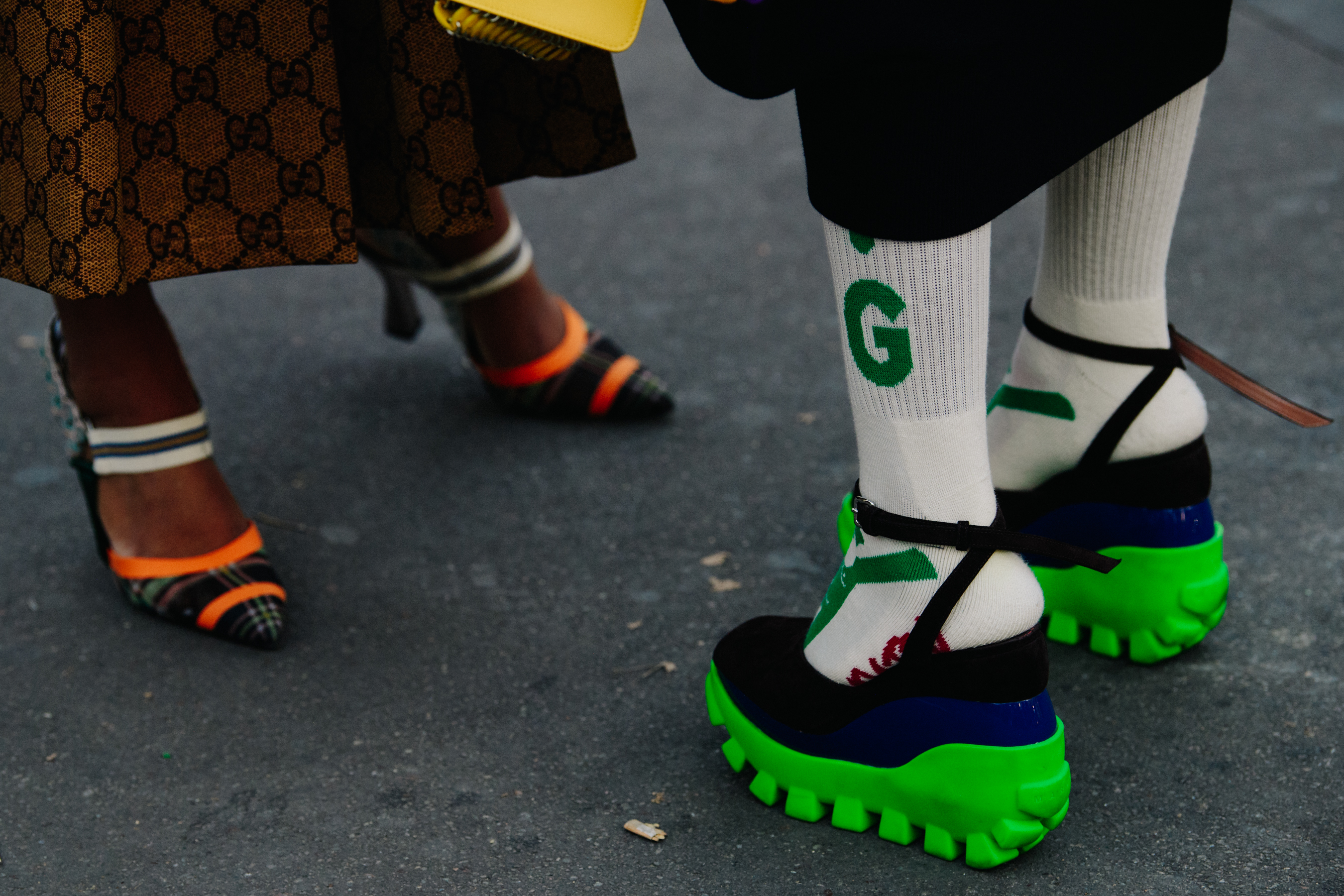 Two women wearing bright heels