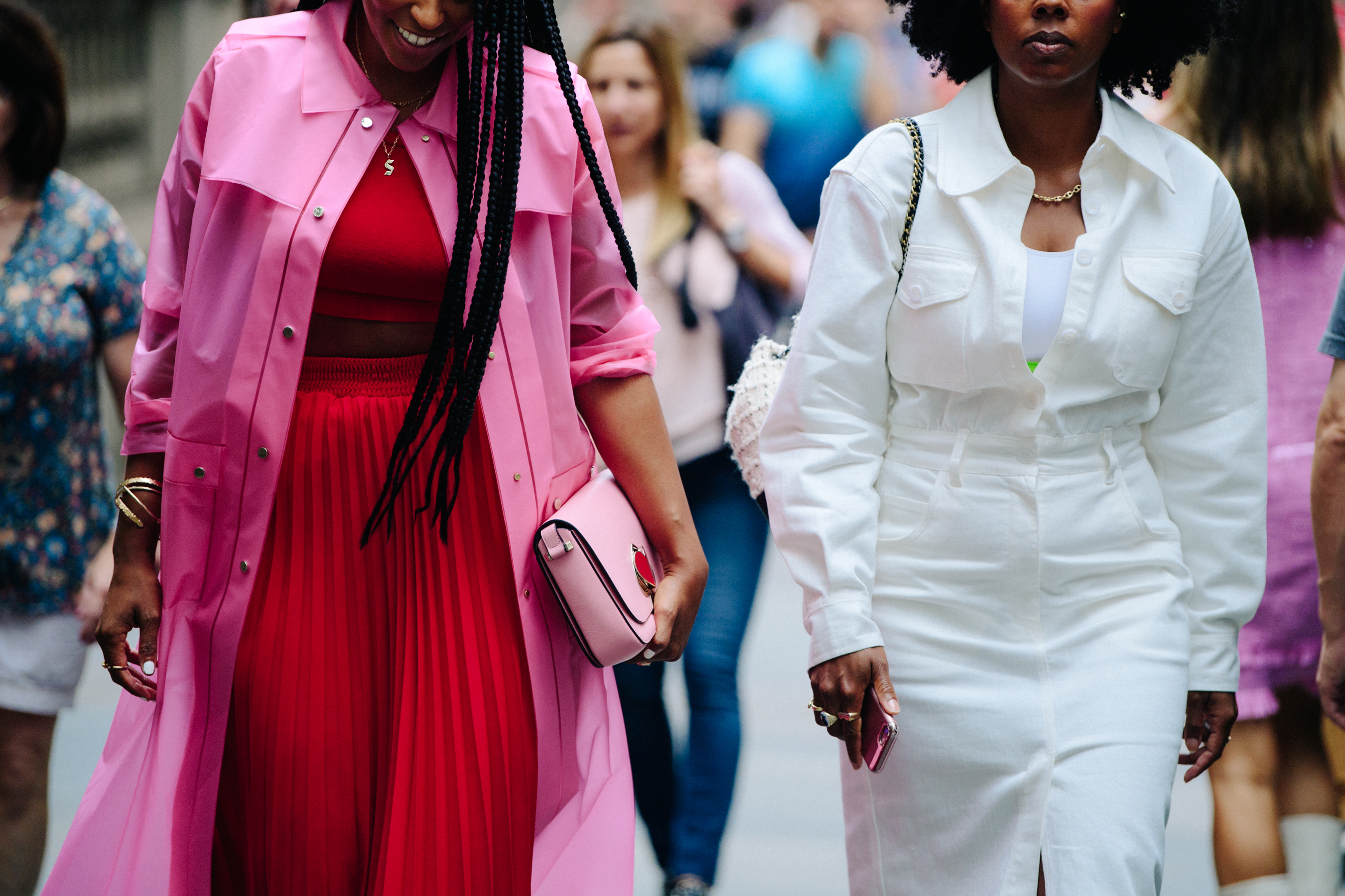 Two women wearing white and pink