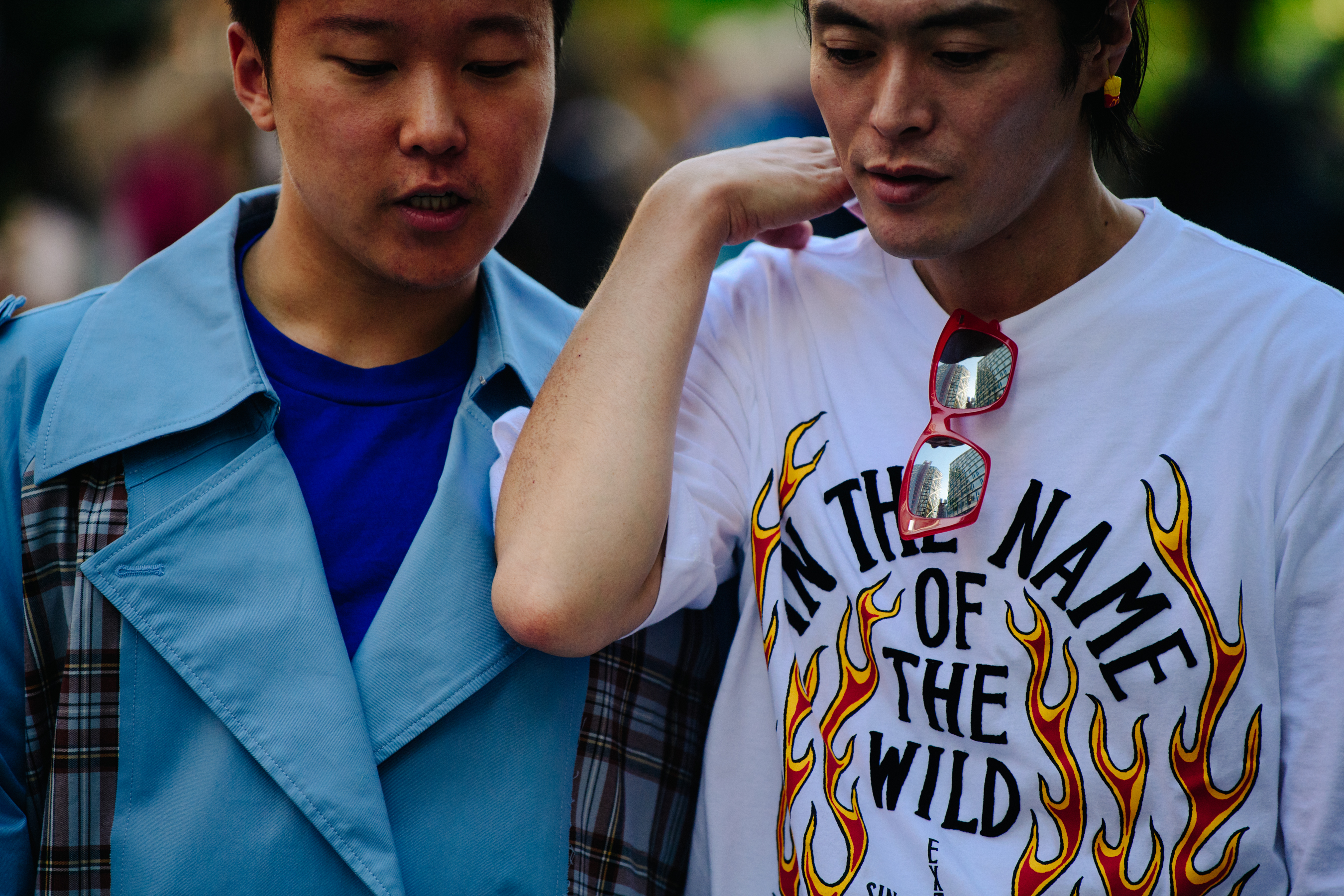 Two Asian men wearing light colours