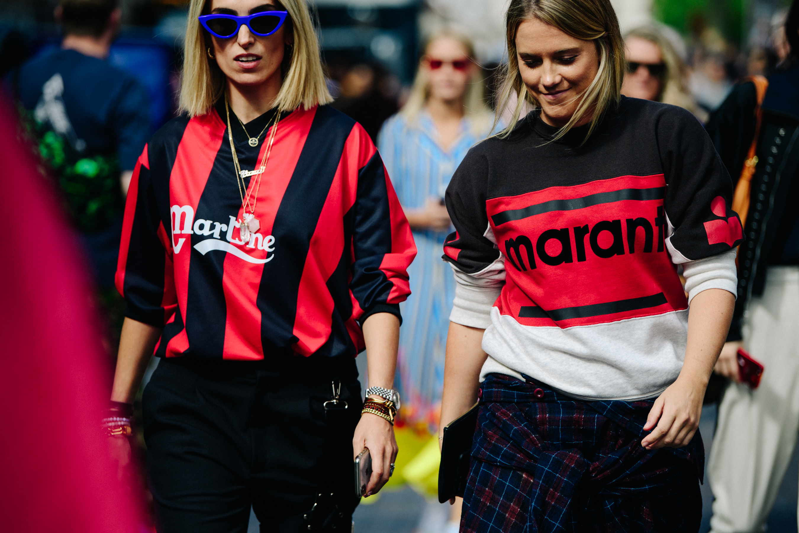 Two women wearing red sports tops
