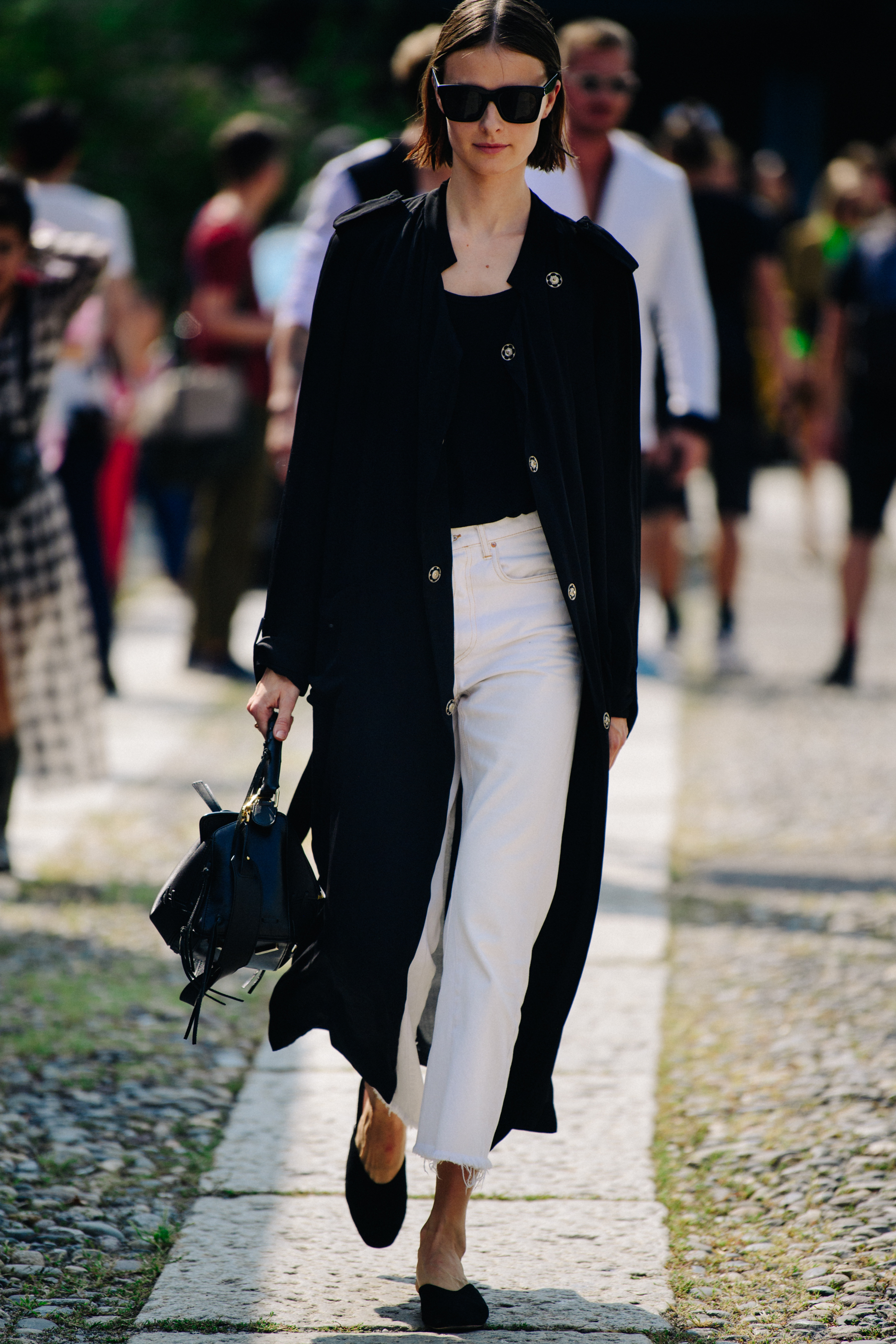 Model wearing white and black pants