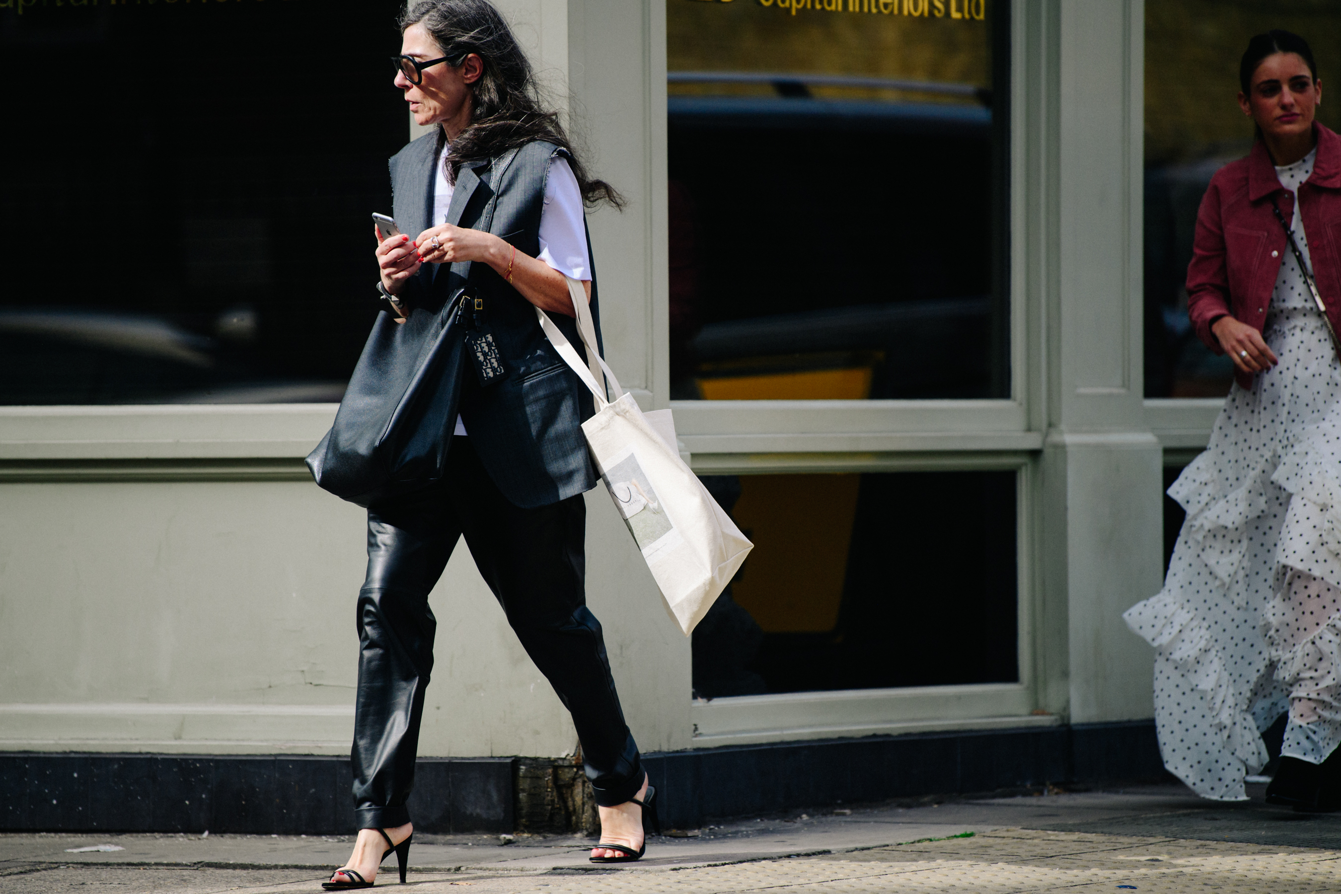 Woman wearing sleeveless suit jacket