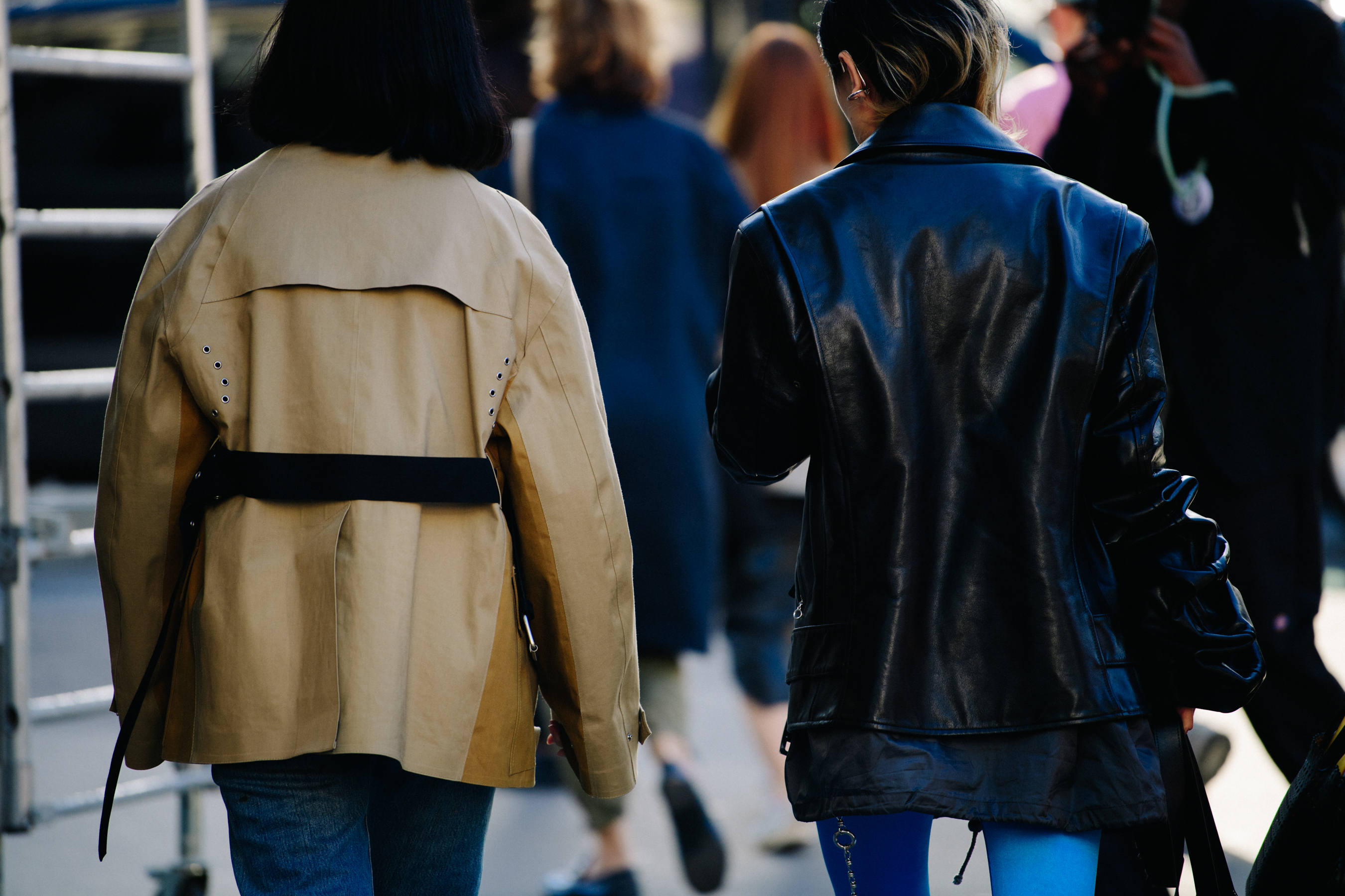 Two women wearing black and tan