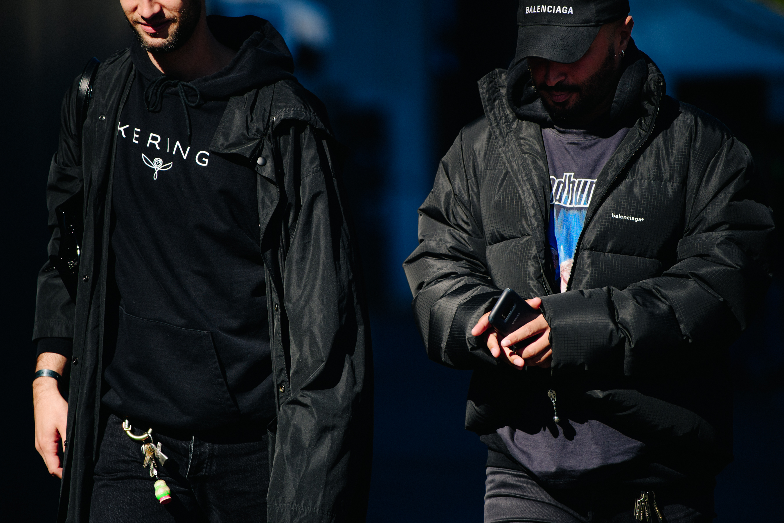 Two men wearing black outfits