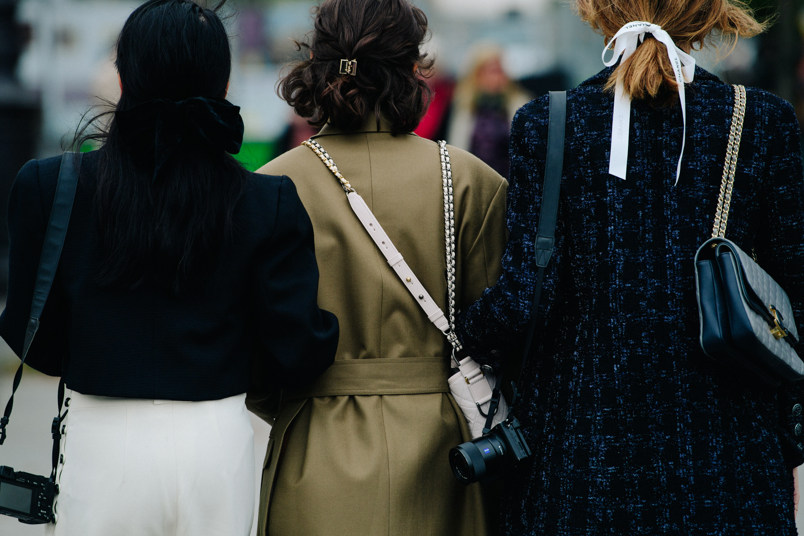 Three women wearing smart jackets